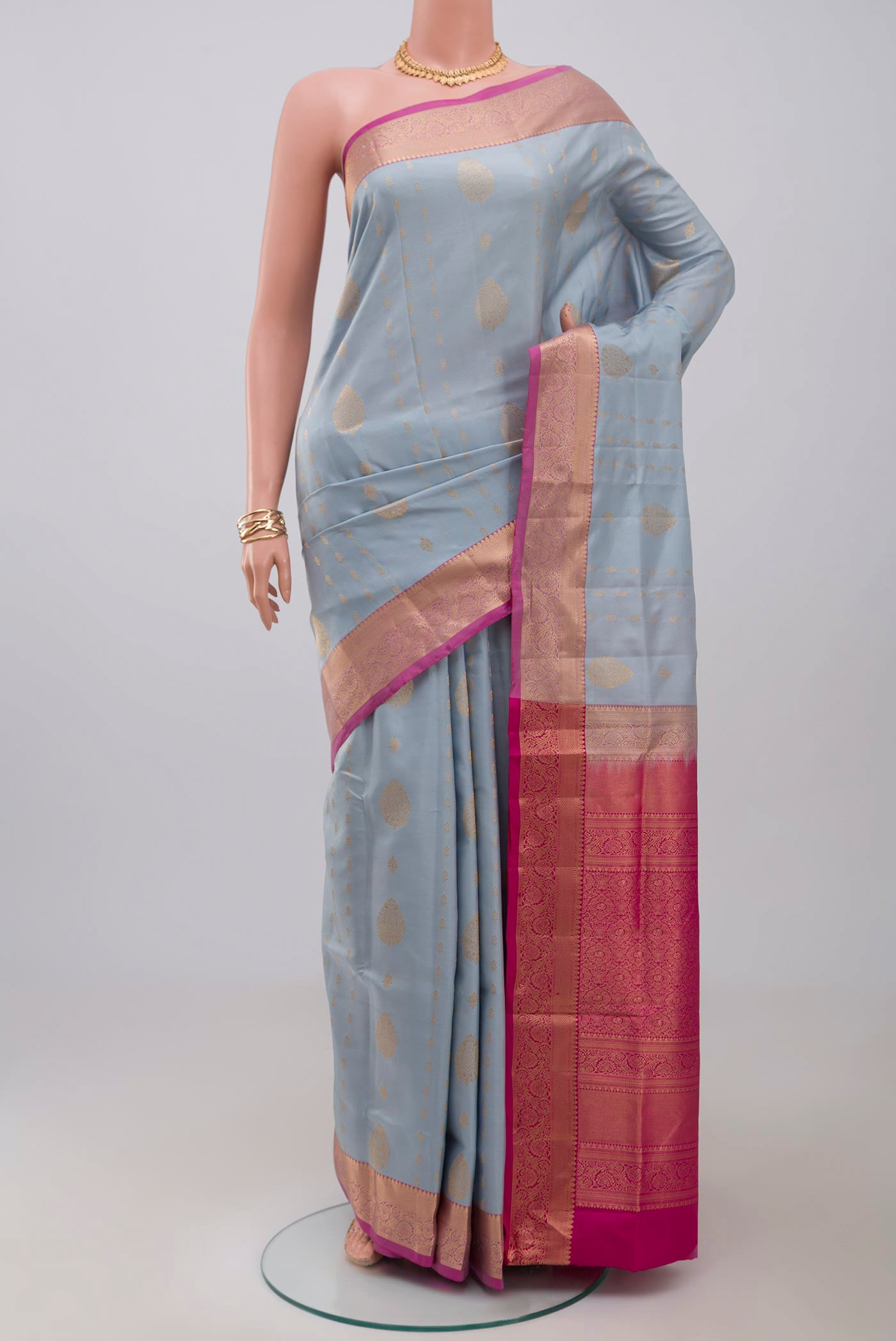 Light Blue Soft Silk Saree with Zari Butta on the body and Zari Border.  displayed on a mannequin
