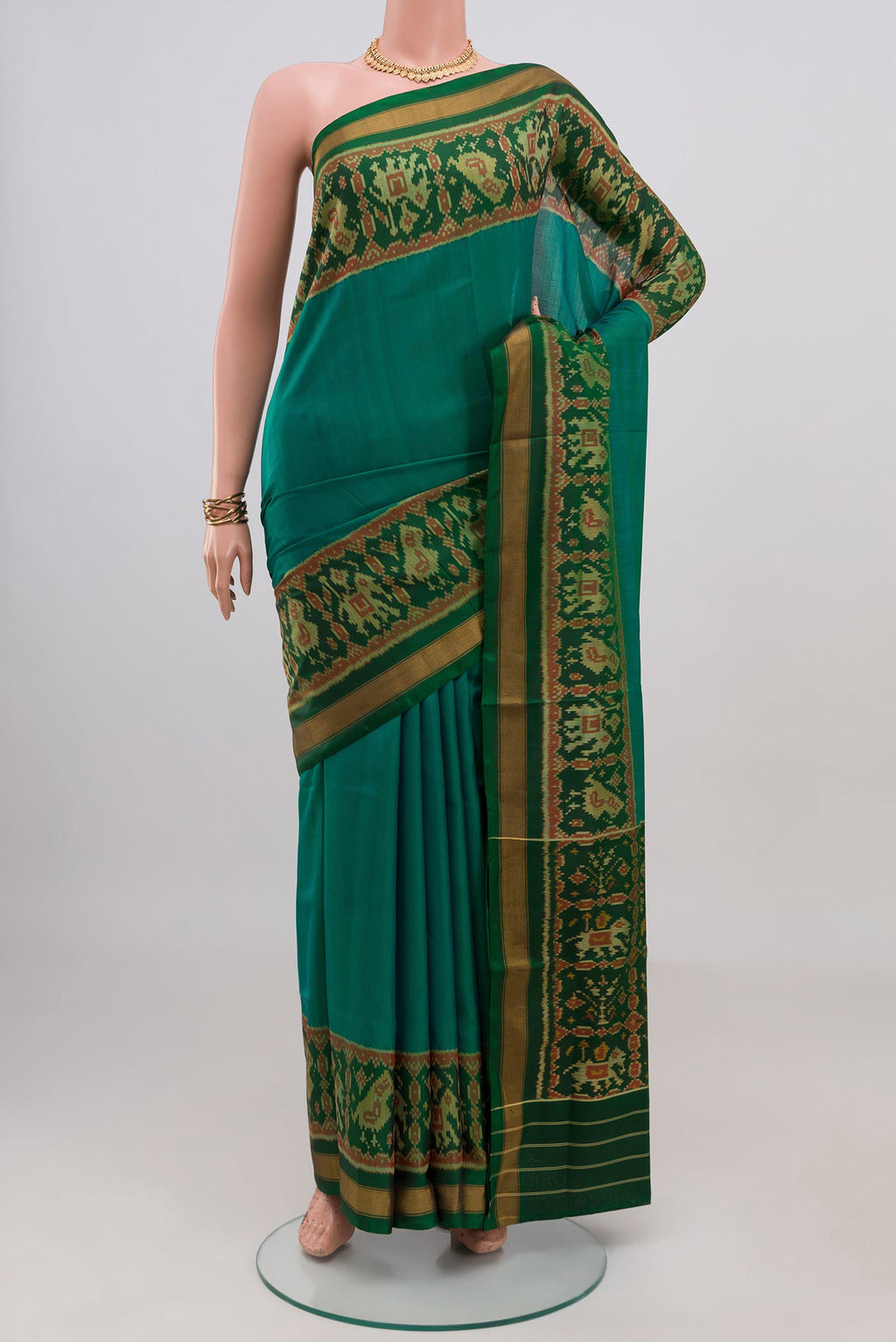 Teal Rajkot Patola Silk Saree with Plain Body and Ikat Border.  displayed on a mannequin