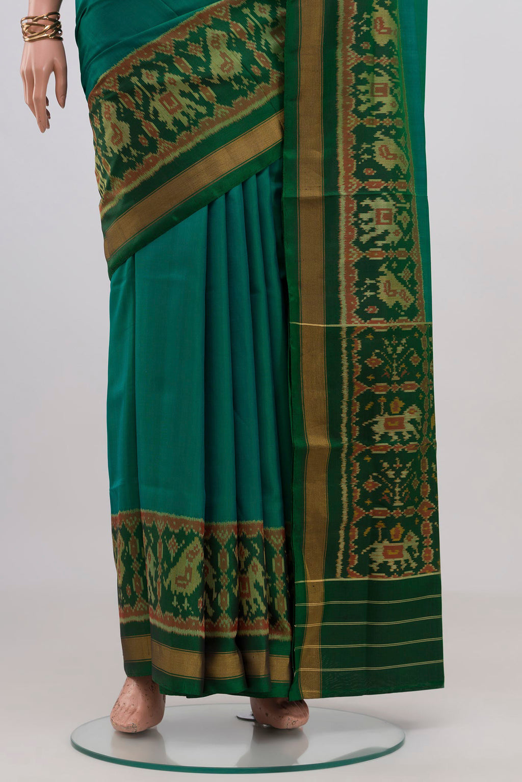 Pleats and pallu of Teal Rajkot Patola Silk Saree with Plain Body and Ikat Border. 