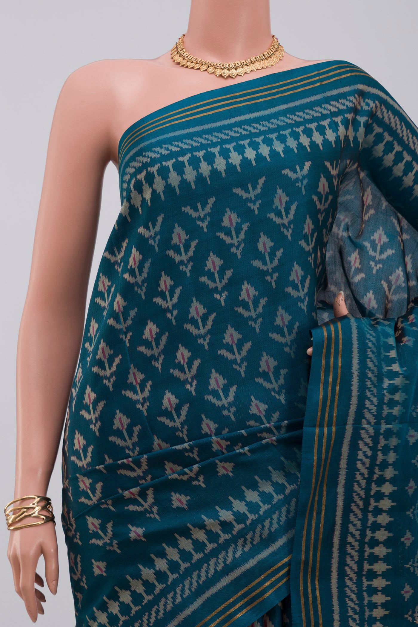 Border image of Blue Rajkot Patola Silk Saree with Ikat design on the body and Thin Zari Line. 