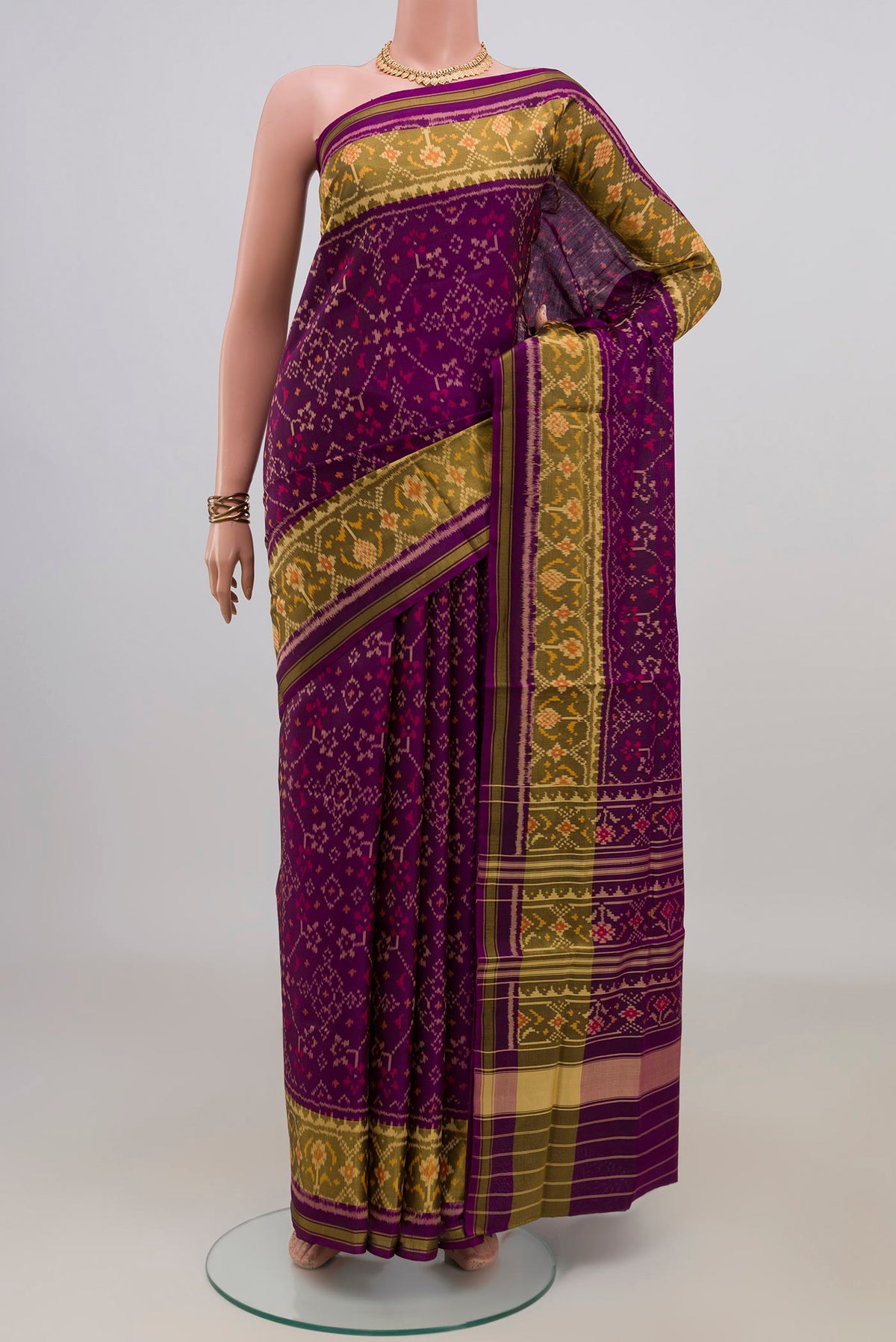 Pure Silk Purple Rajkot Patola Saree with Ikat design on the body and Ikat Border.  displayed on a mannequin