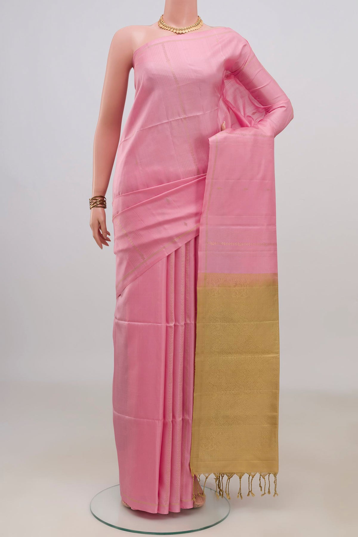 Pure Silk Pink Soft Saree with Fancy on the body and Thin Zari Line.  displayed on a mannequin