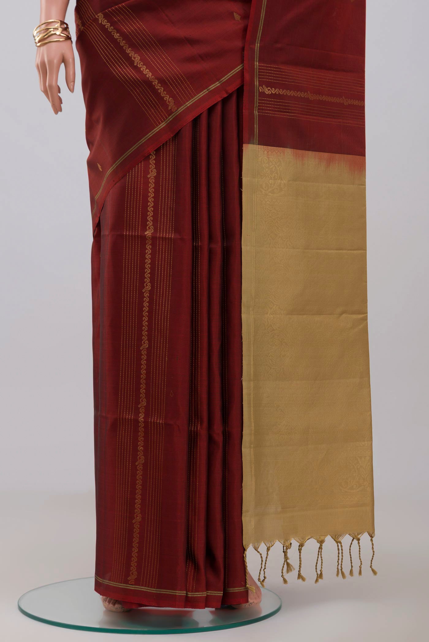 Pleats and pallu of Maroon Soft Silk Saree with Fancy on the body and Thin Zari Line. 