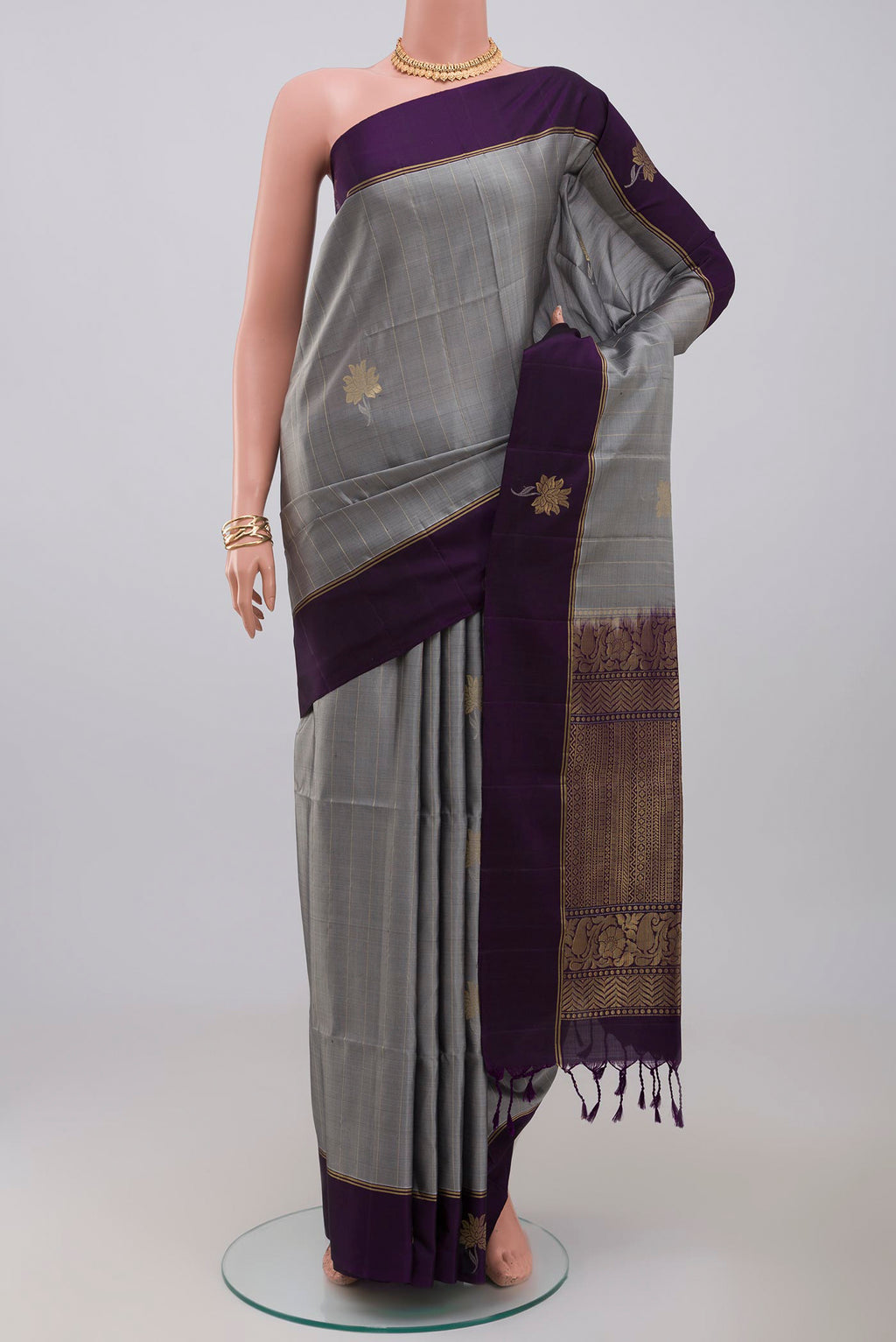 Grey Soft Silk Saree with Fancy on the body and Thin Zari Line.  displayed on a mannequin
