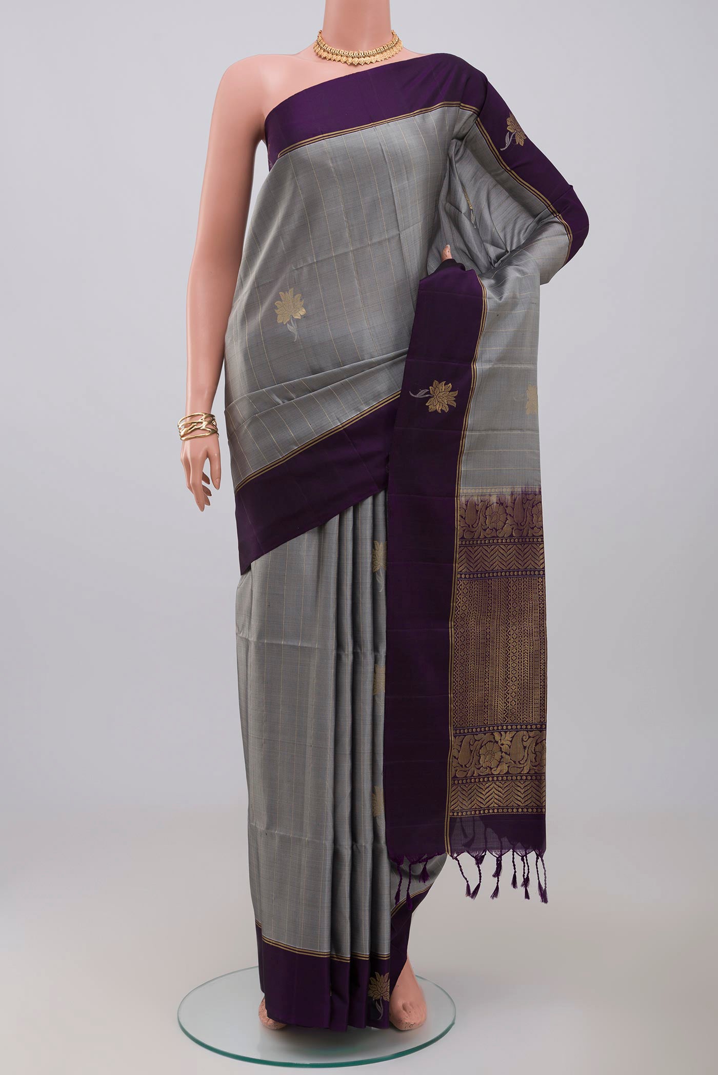 Grey Soft Silk Saree with Fancy on the body and Thin Zari Line.  displayed on a mannequin