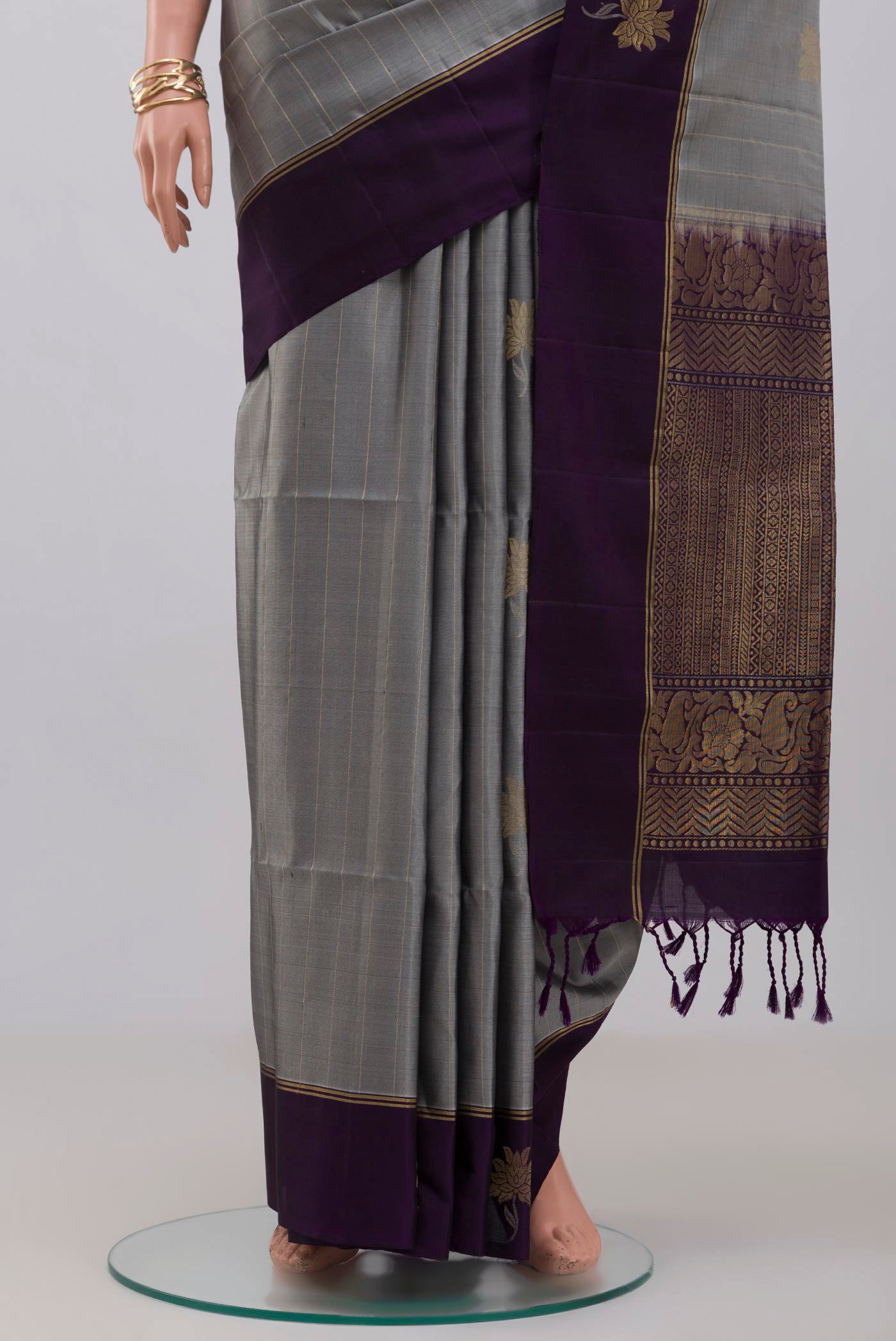 Pleats and pallu of Grey Soft Silk Saree with Fancy on the body and Thin Zari Line. 
