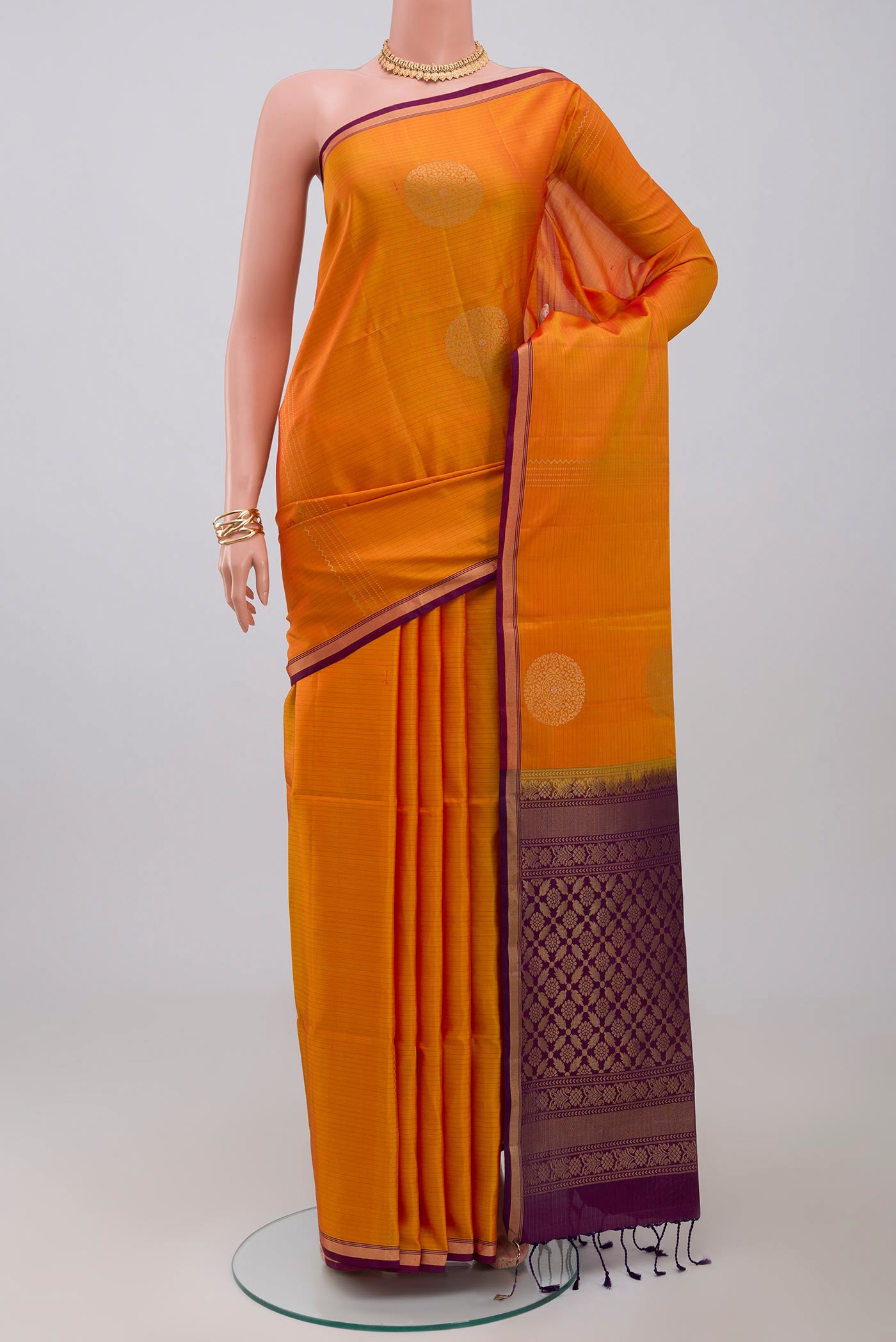 Yellow Soft Silk Saree with Fancy on the body and Thin Zari Line.  displayed on a mannequin