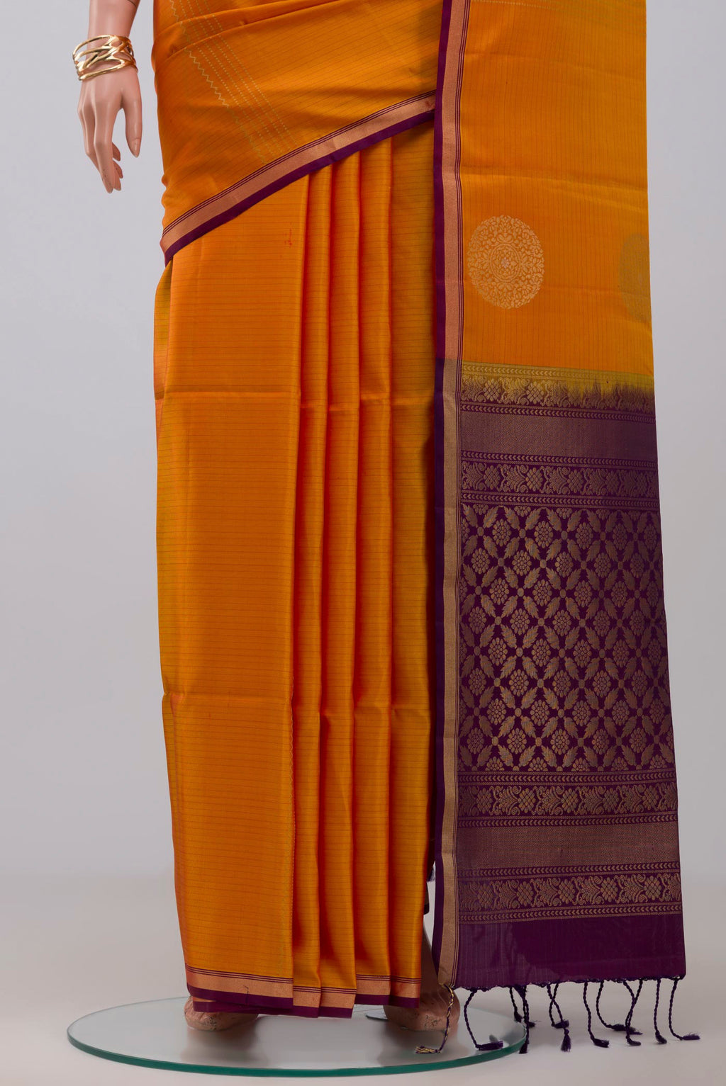 Pleats and pallu of Yellow Soft Silk Saree with Fancy on the body and Thin Zari Line. 