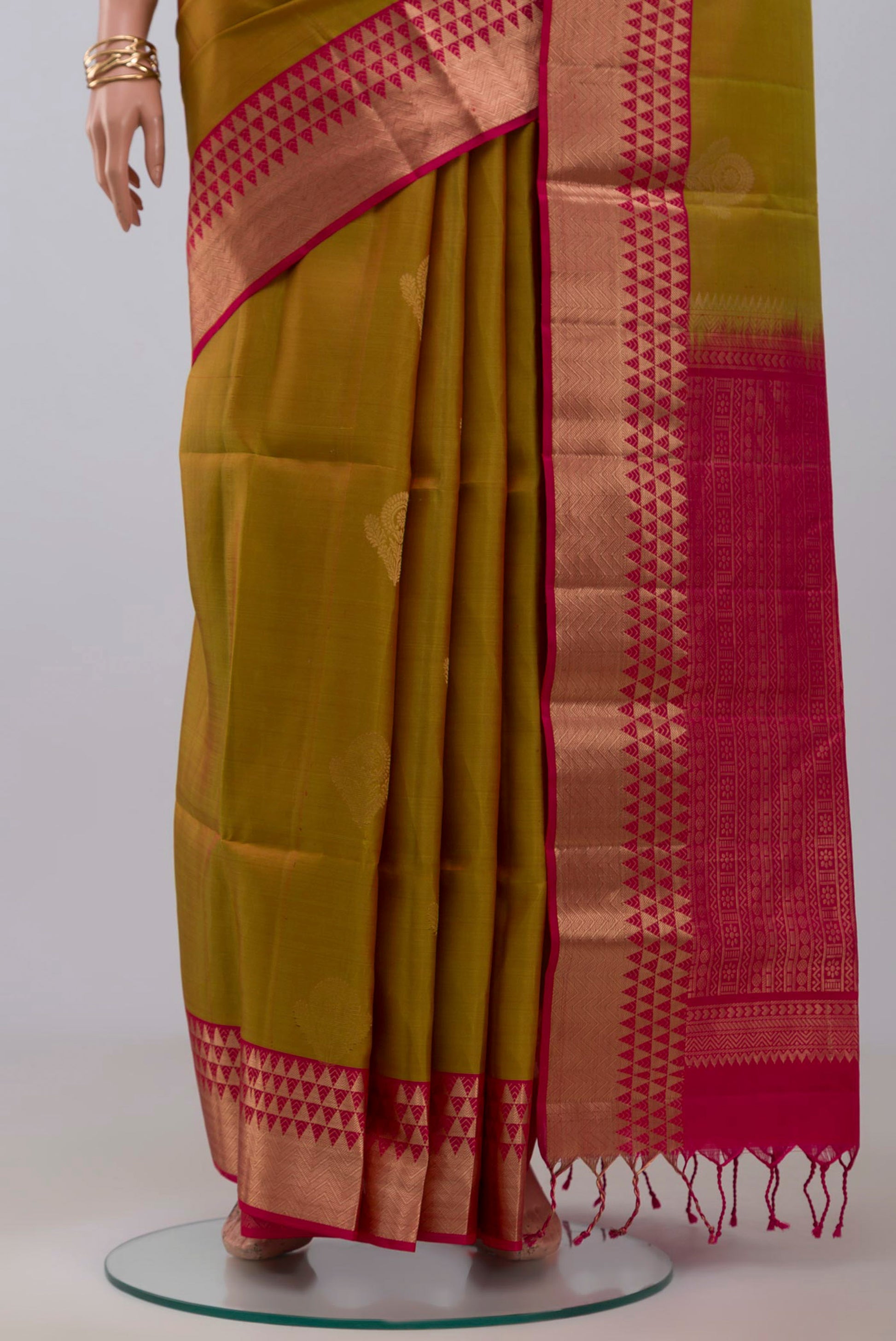 Pleats and pallu of Green Soft Silk Saree with Zari Butta on the body and Zari Border. 