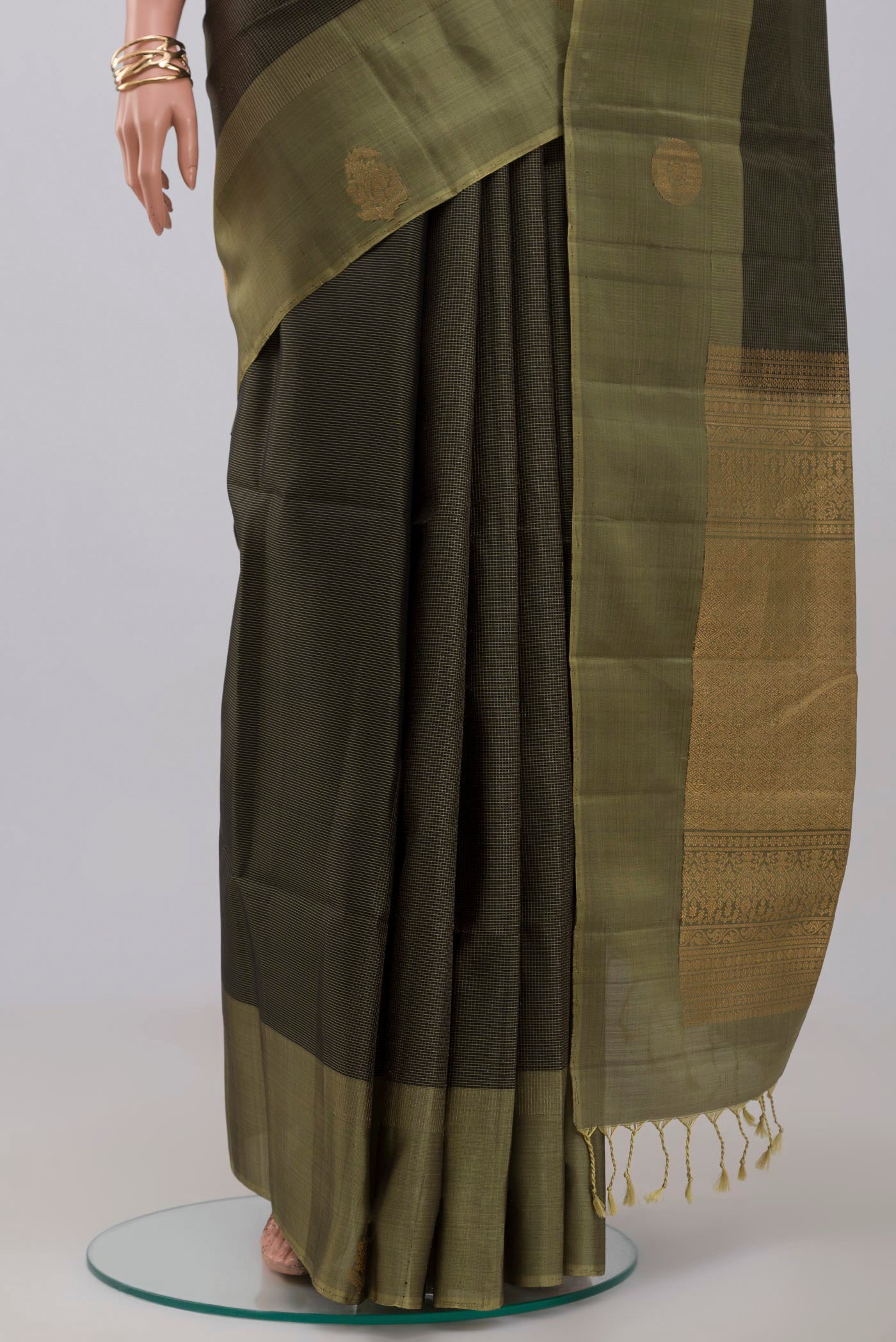 Pleats and pallu of Black Soft Silk Saree with Checked design on the body and Fancy Border. 