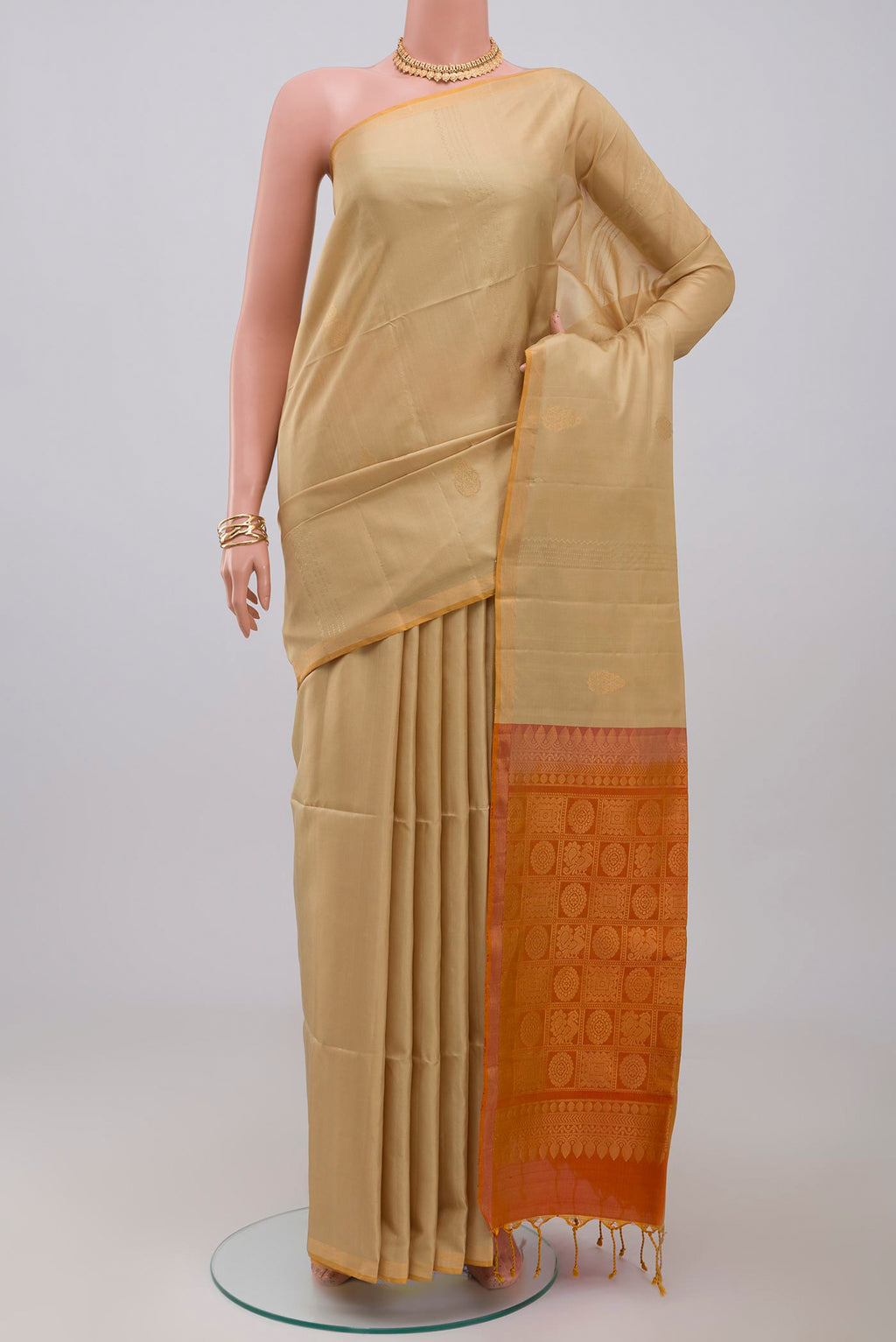 Cream Soft Silk Saree with Fancy on the body and Thin Zari Line.  displayed on a mannequin