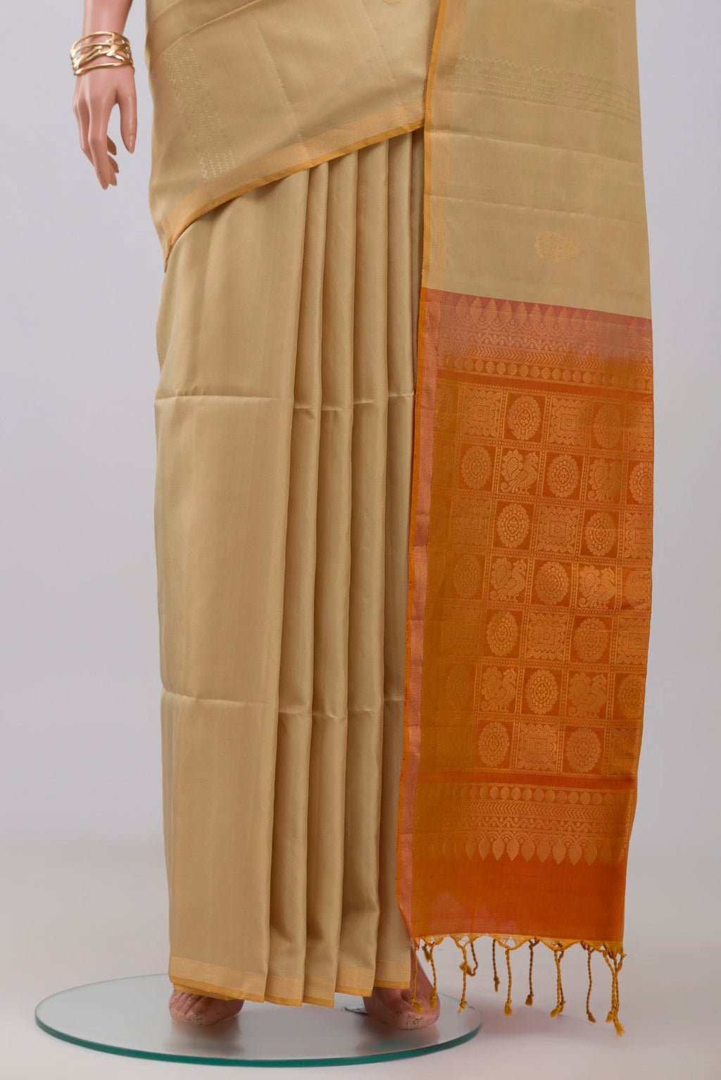 Pleats and pallu of Cream Soft Silk Saree with Fancy on the body and Thin Zari Line. 