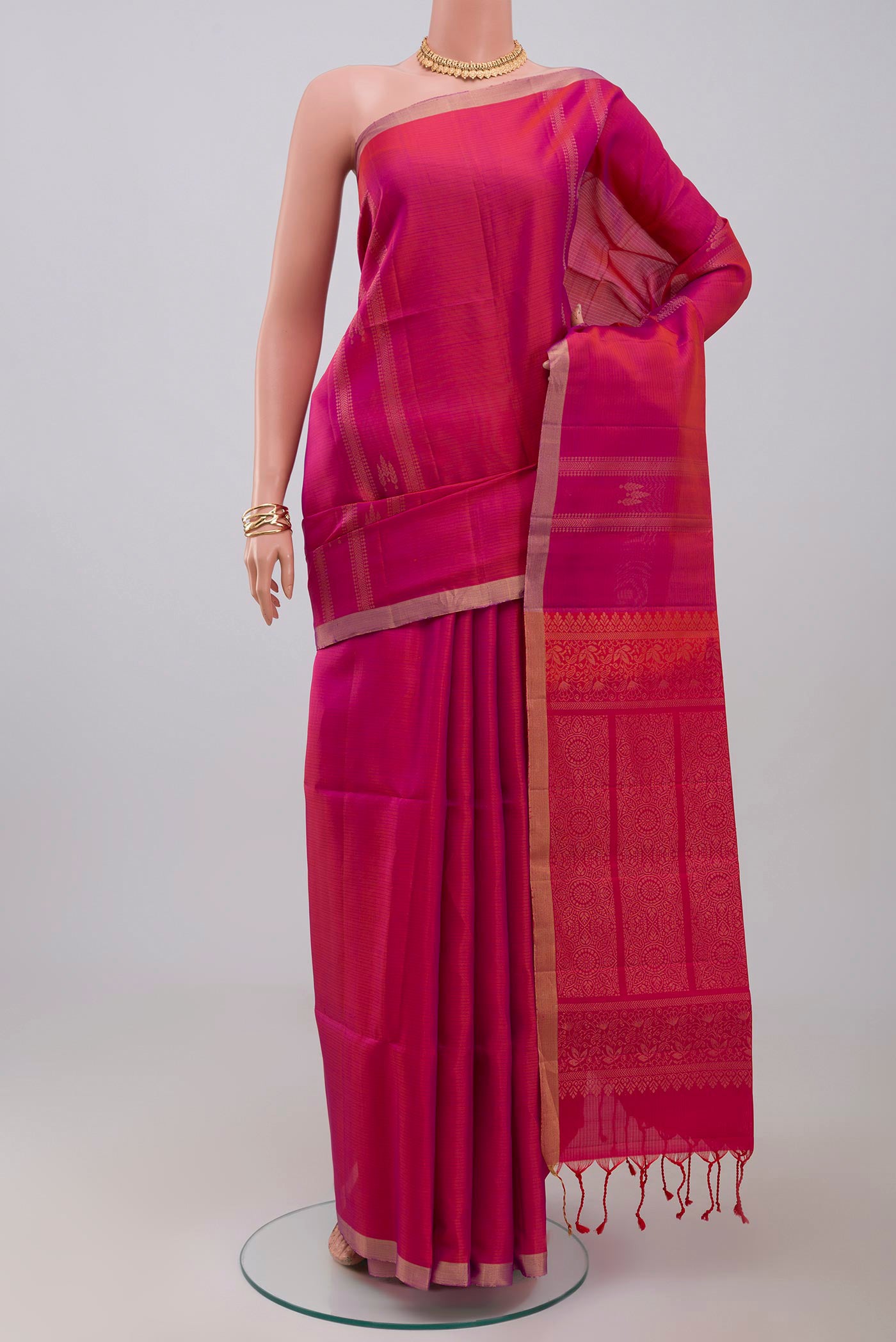 Pink Soft Silk Saree with Zari Butta on the body and Thin Zari Line.  displayed on a mannequin