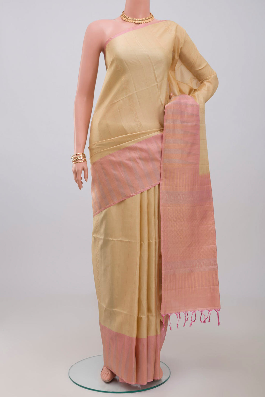 Cream Soft Silk Saree with Fancy on the body and Fancy Border.  displayed on a mannequin