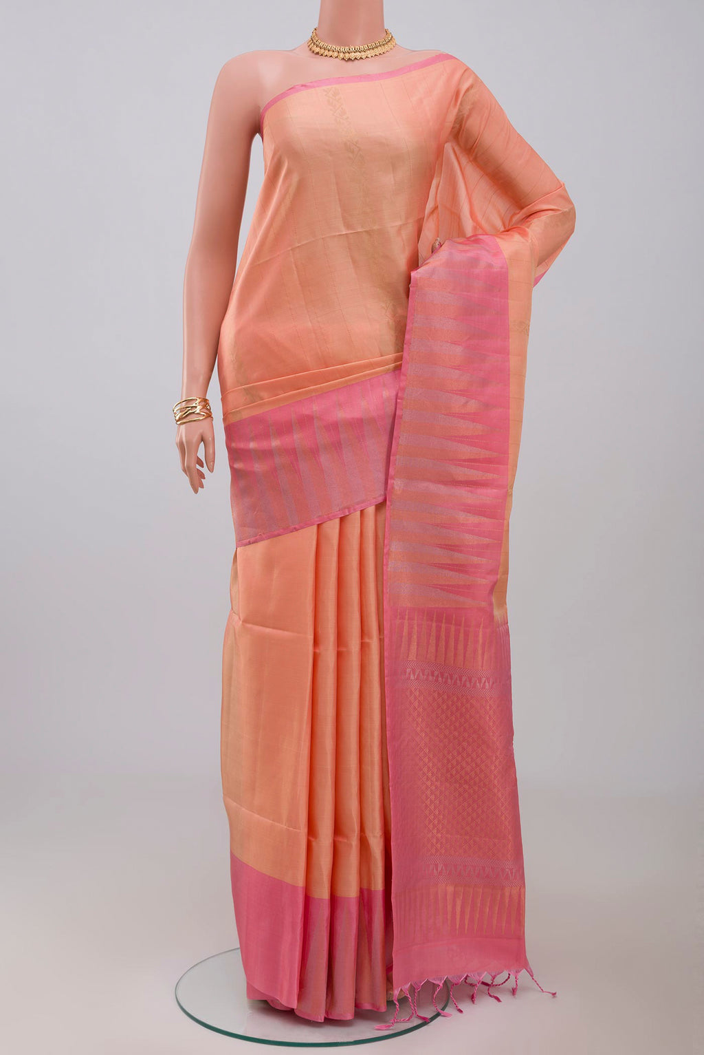Peach Soft Silk Saree with Fancy on the body and Fancy Border.  displayed on a mannequin