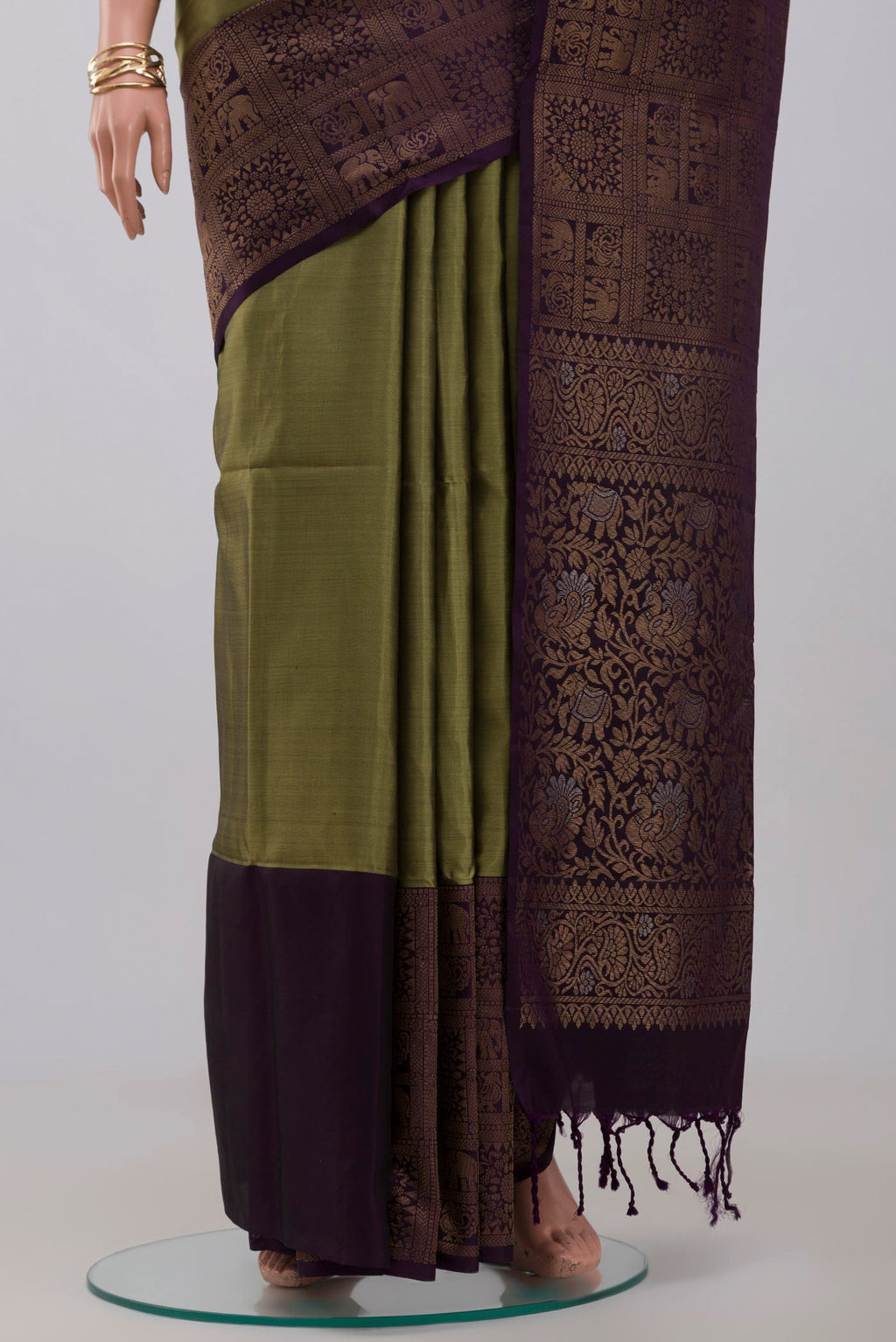 Pleats and pallu of Mehandi Green Soft Silk Saree with Zari Butta on the body and Fancy Border. 