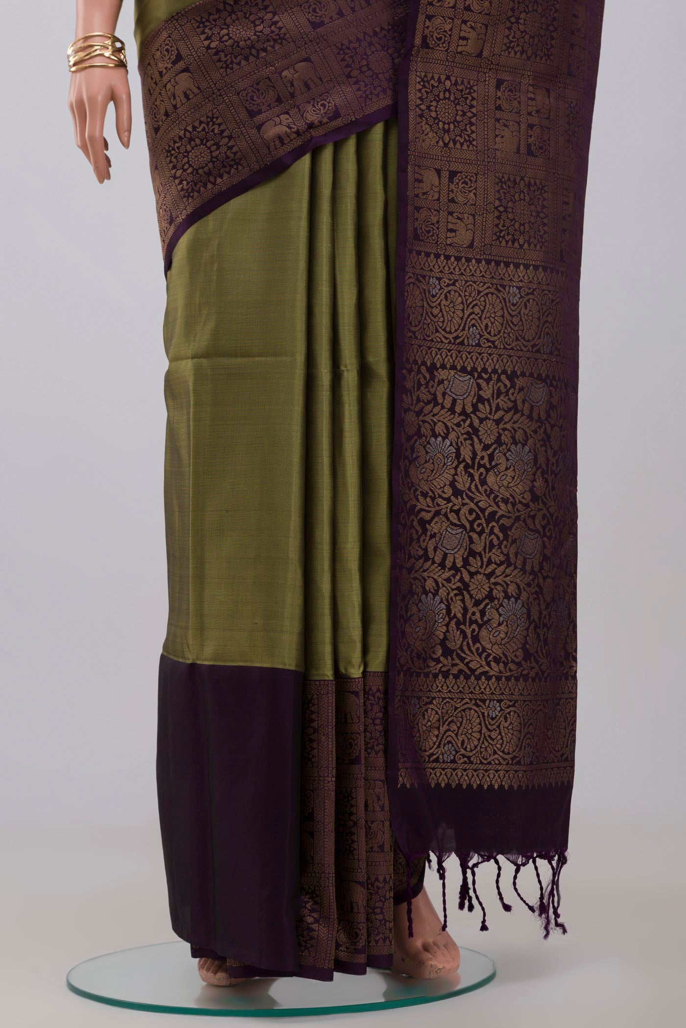 Pleats and pallu of Mehandi Green Soft Silk Saree with Zari Butta on the body and Fancy Border. 