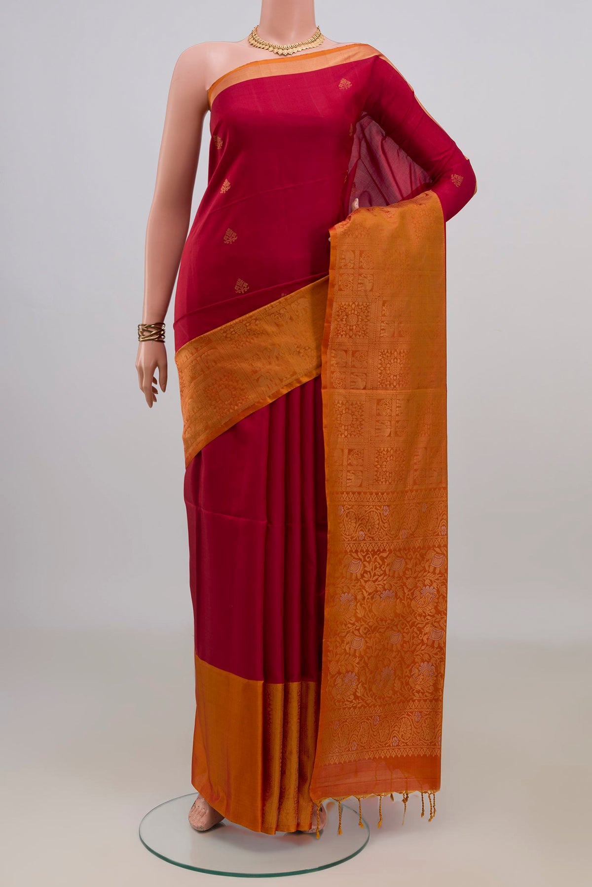 Pure Silk Red Soft Saree with Zari Butta on the body and Fancy Border.  displayed on a mannequin