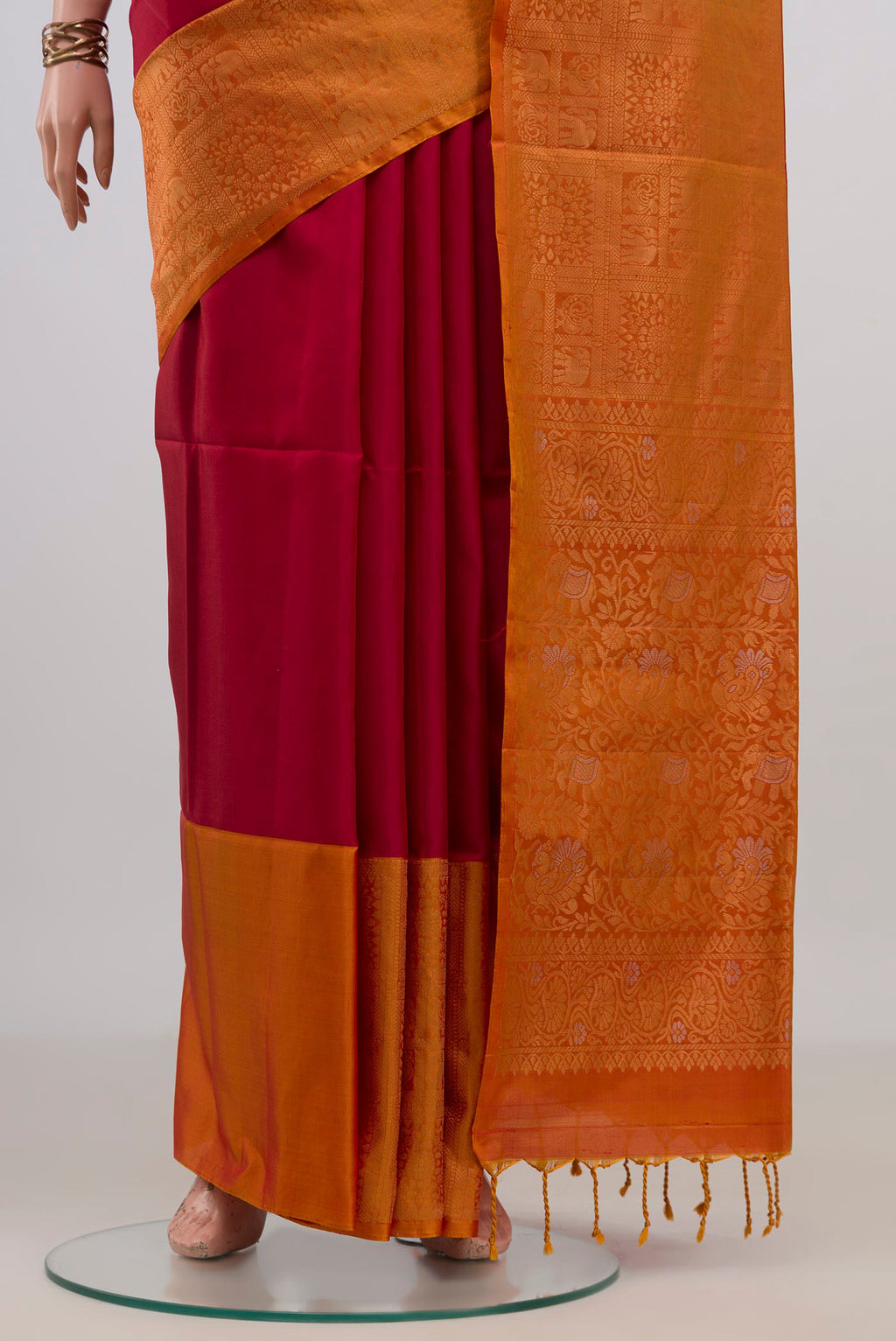 Pleats and pallu of Pure Silk Red Soft Saree with Zari Butta on the body and Fancy Border. 