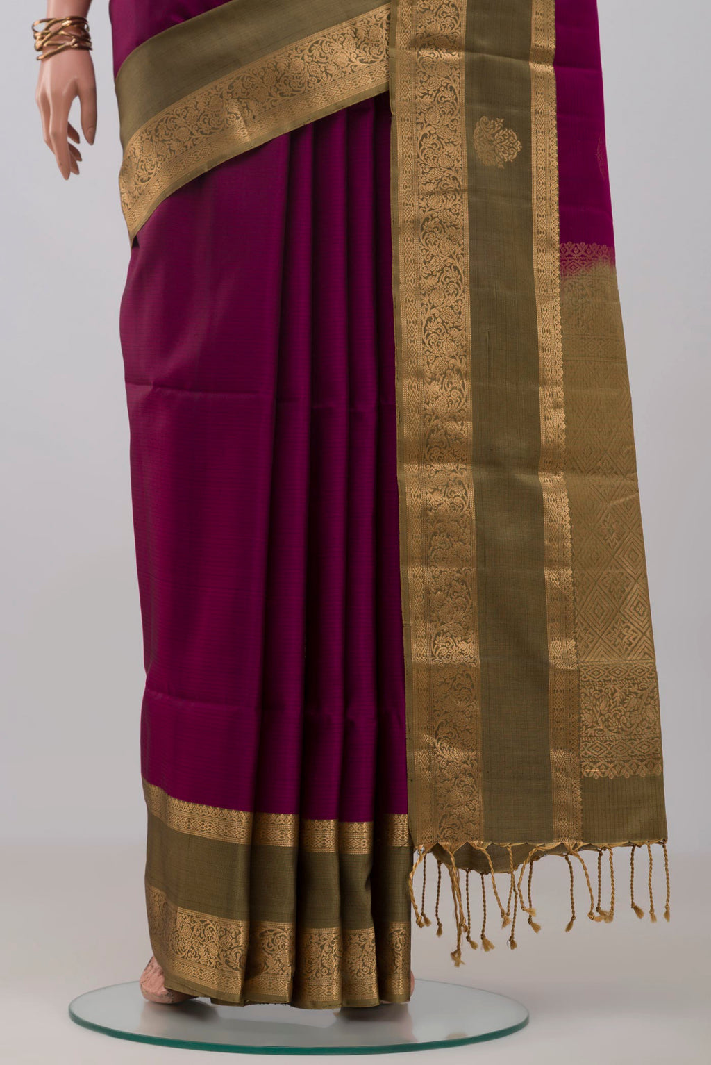 Pleats and pallu of Purple Soft Silk Saree with Zari Butta on the body and Zari Border. 