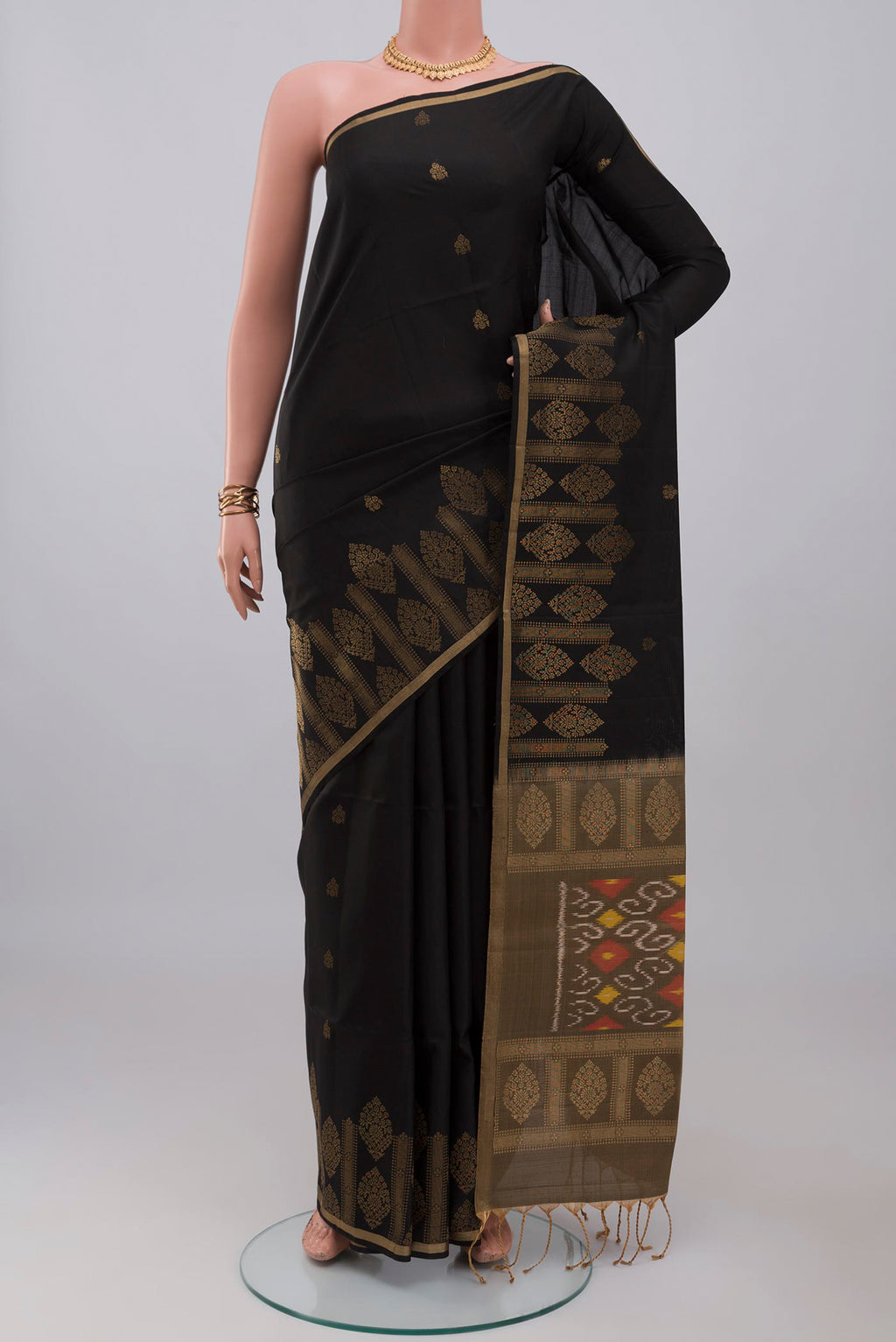 Black Soft Silk Saree with Zari Butta on the body and Fancy Border.  displayed on a mannequin