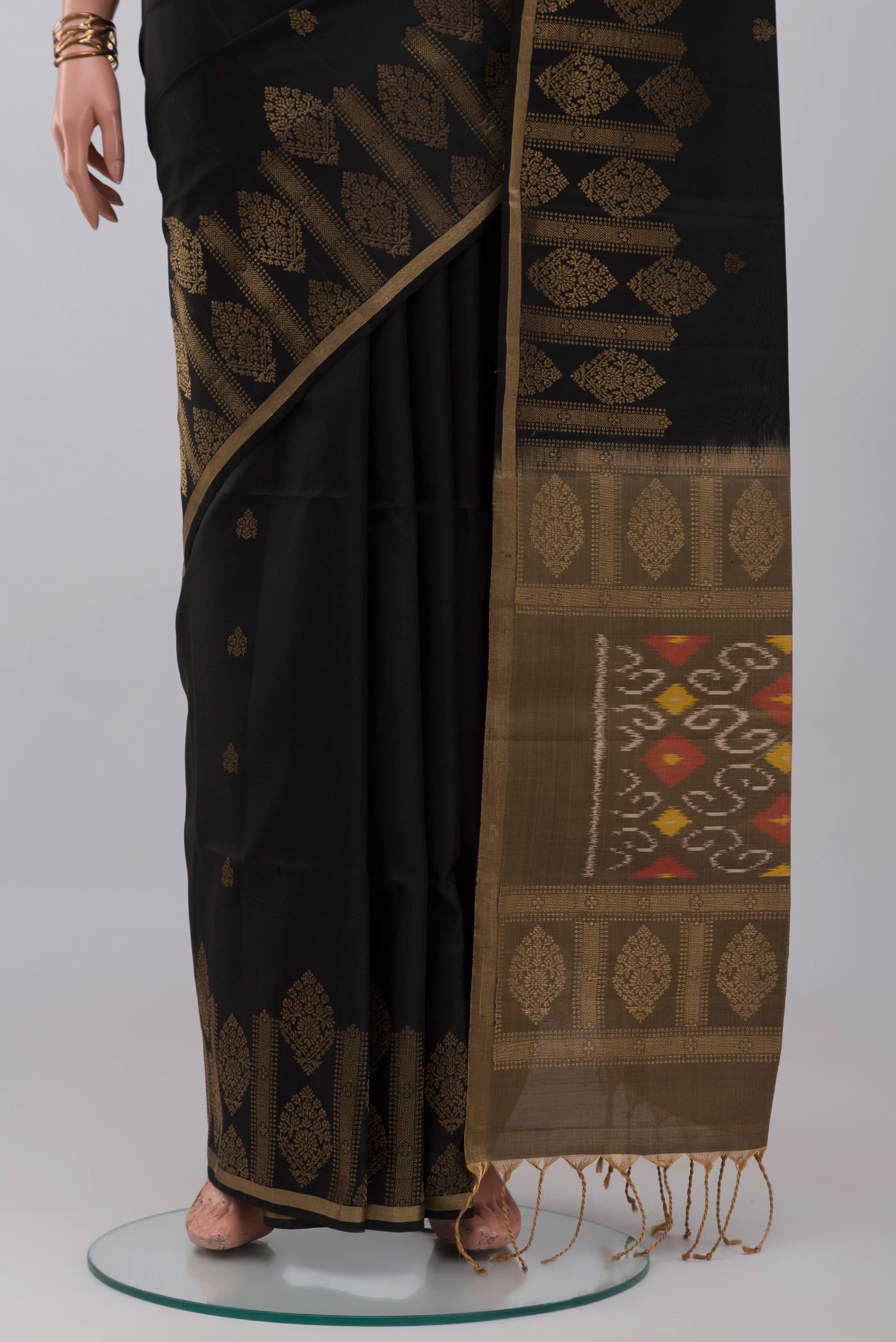 Pleats and pallu of Black Soft Silk Saree with Zari Butta on the body and Fancy Border. 