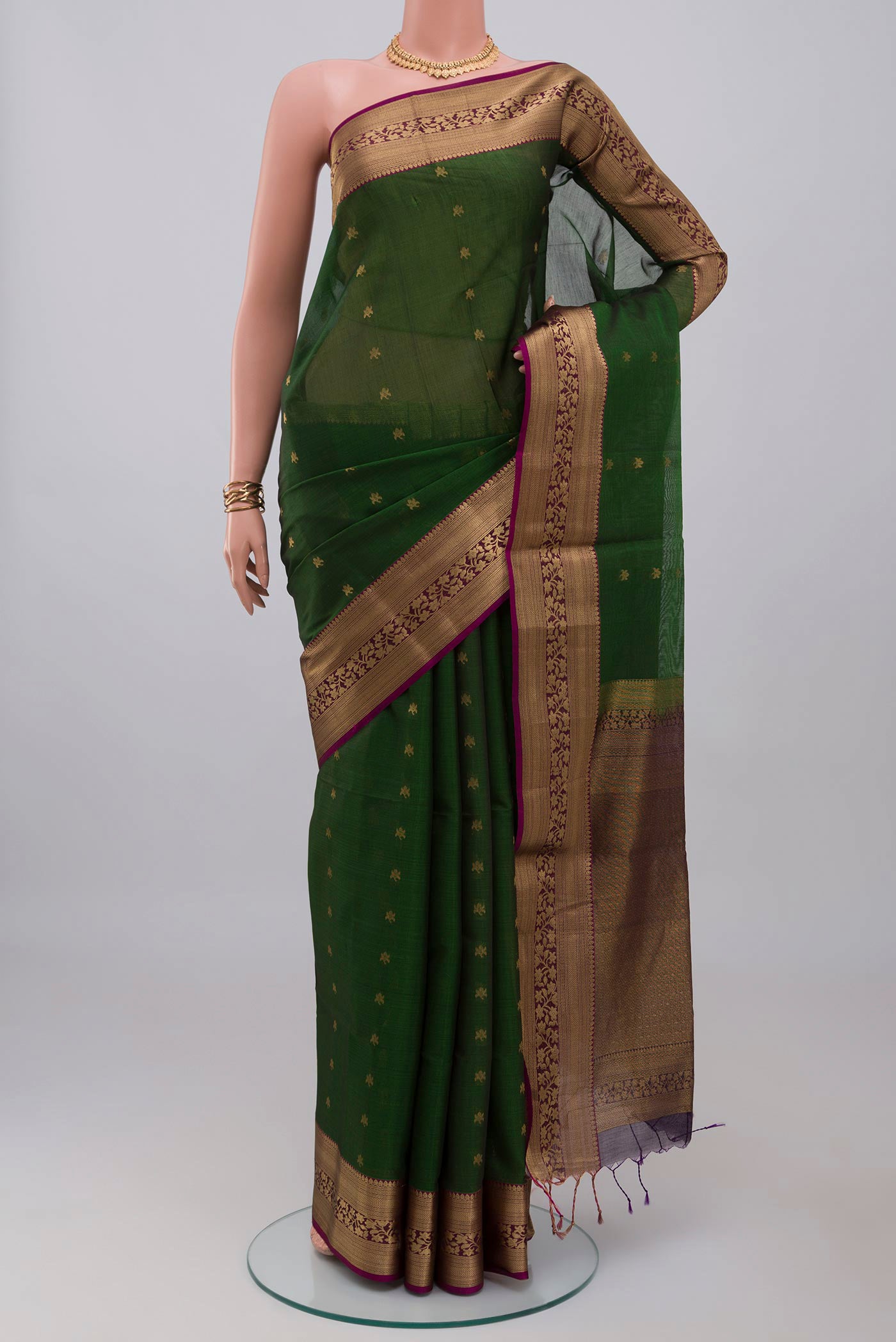Green Silk Cotton Saree with Zari Butta on the body and Zari Border.  displayed on a mannequin