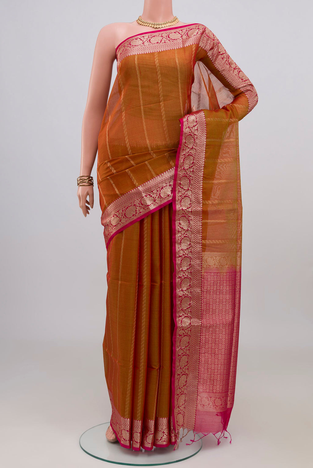 Mustard Dual Tone Silk Cotton Saree with Stripes on the body and Zari Border.  displayed on a mannequin