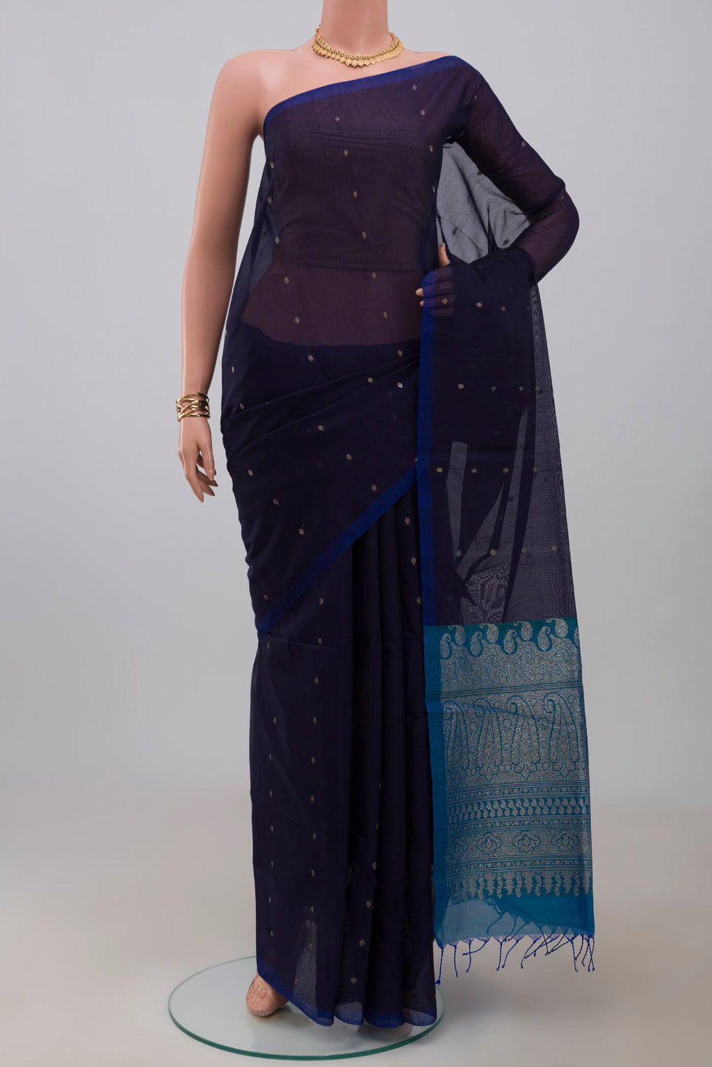 Navy Blue Silk Cotton Saree with Zari Butta on the body and Without Border.  displayed on a mannequin