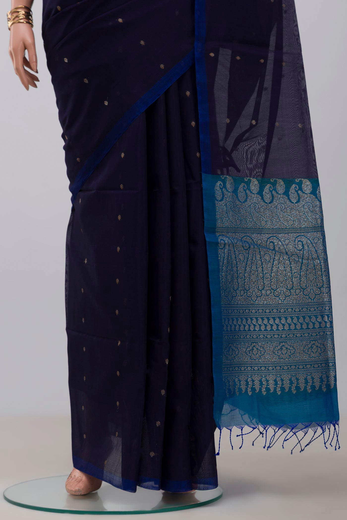 Pleats and pallu of Navy Blue Silk Cotton Saree with Zari Butta on the body and Without Border. 