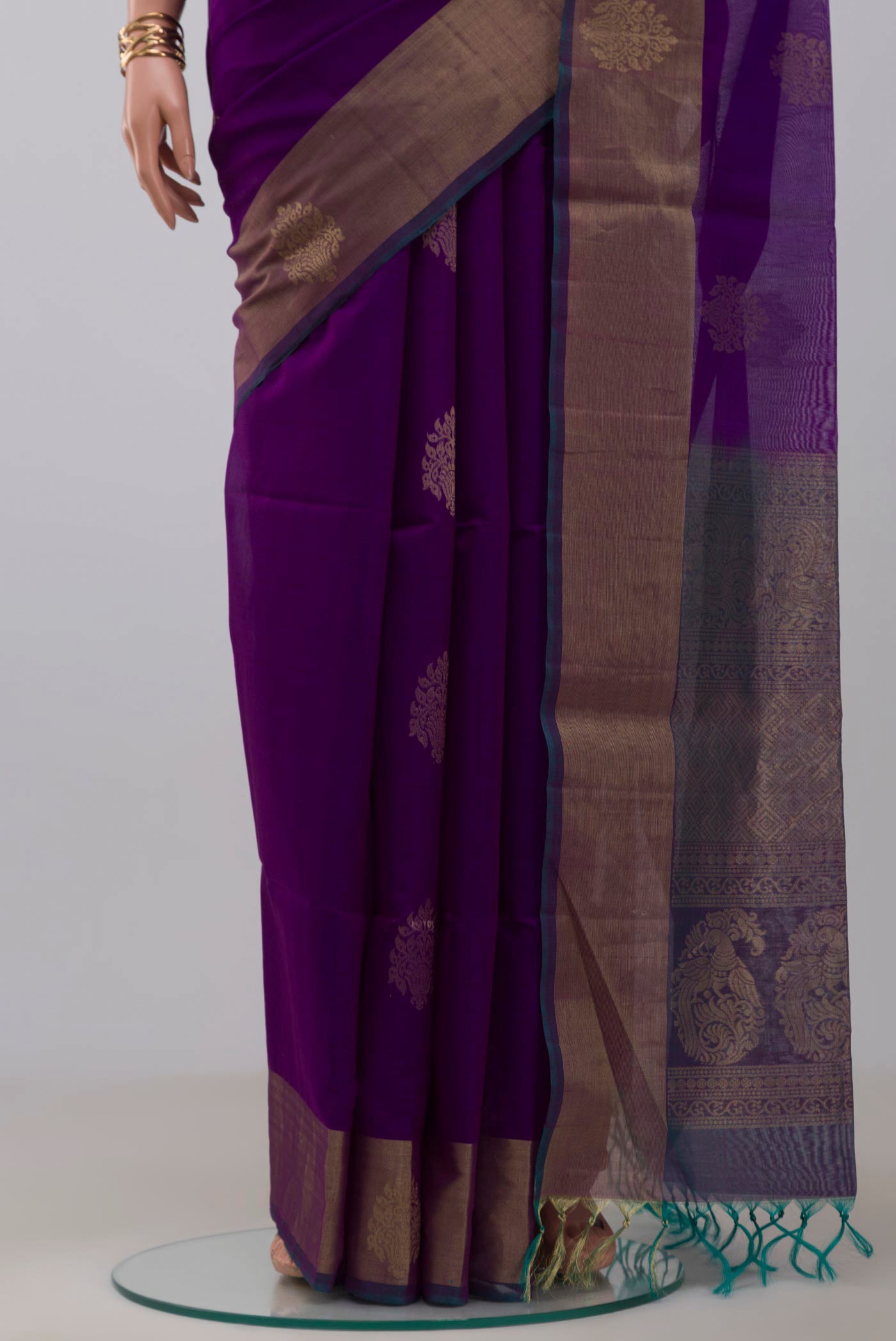 Pleats and pallu of Purple Silk Cotton Saree with Zari Butta on the body and Zari Border. 