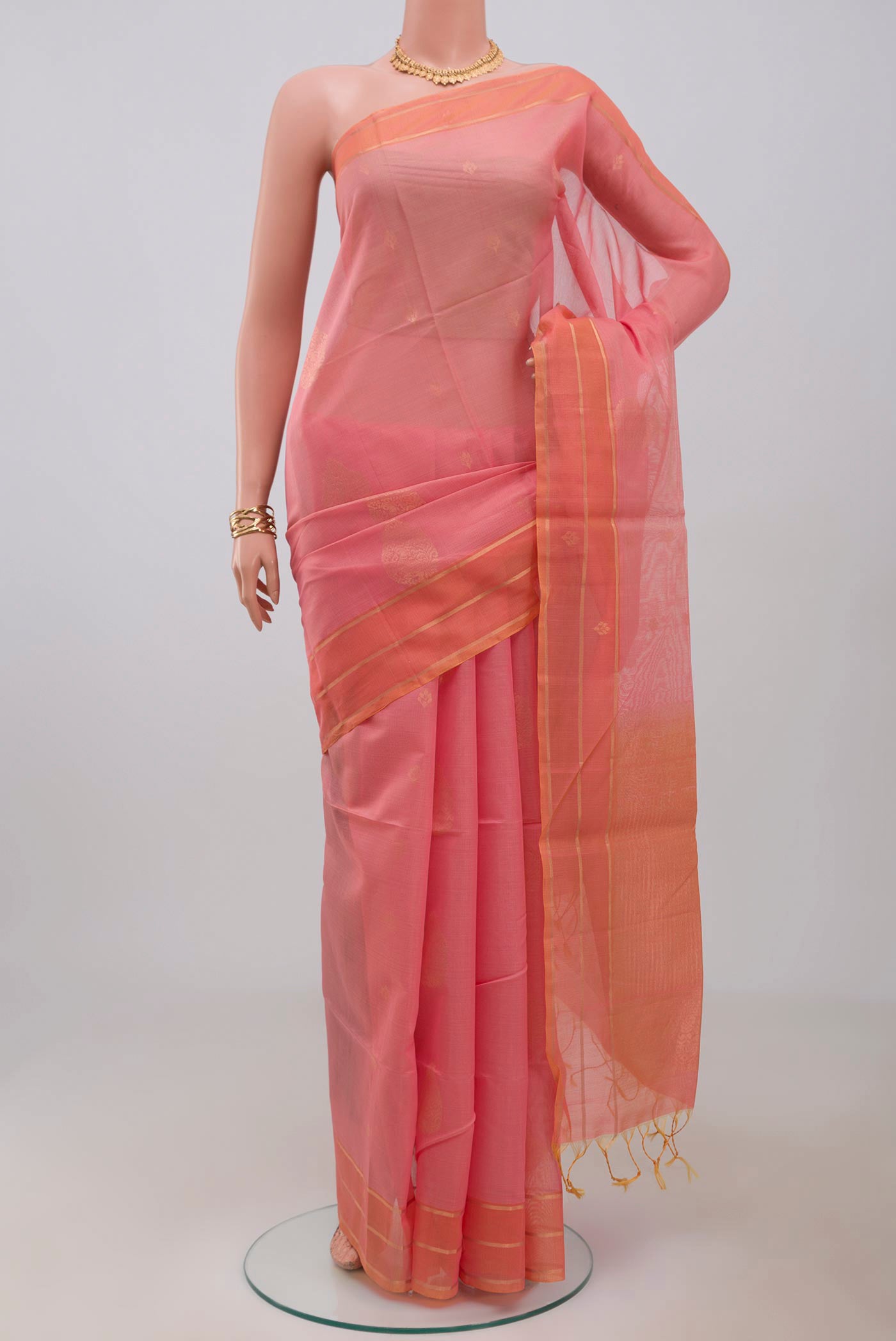 Pink Silk Cotton Saree with Zari Butta on the body and Thin Zari Line.  displayed on a mannequin