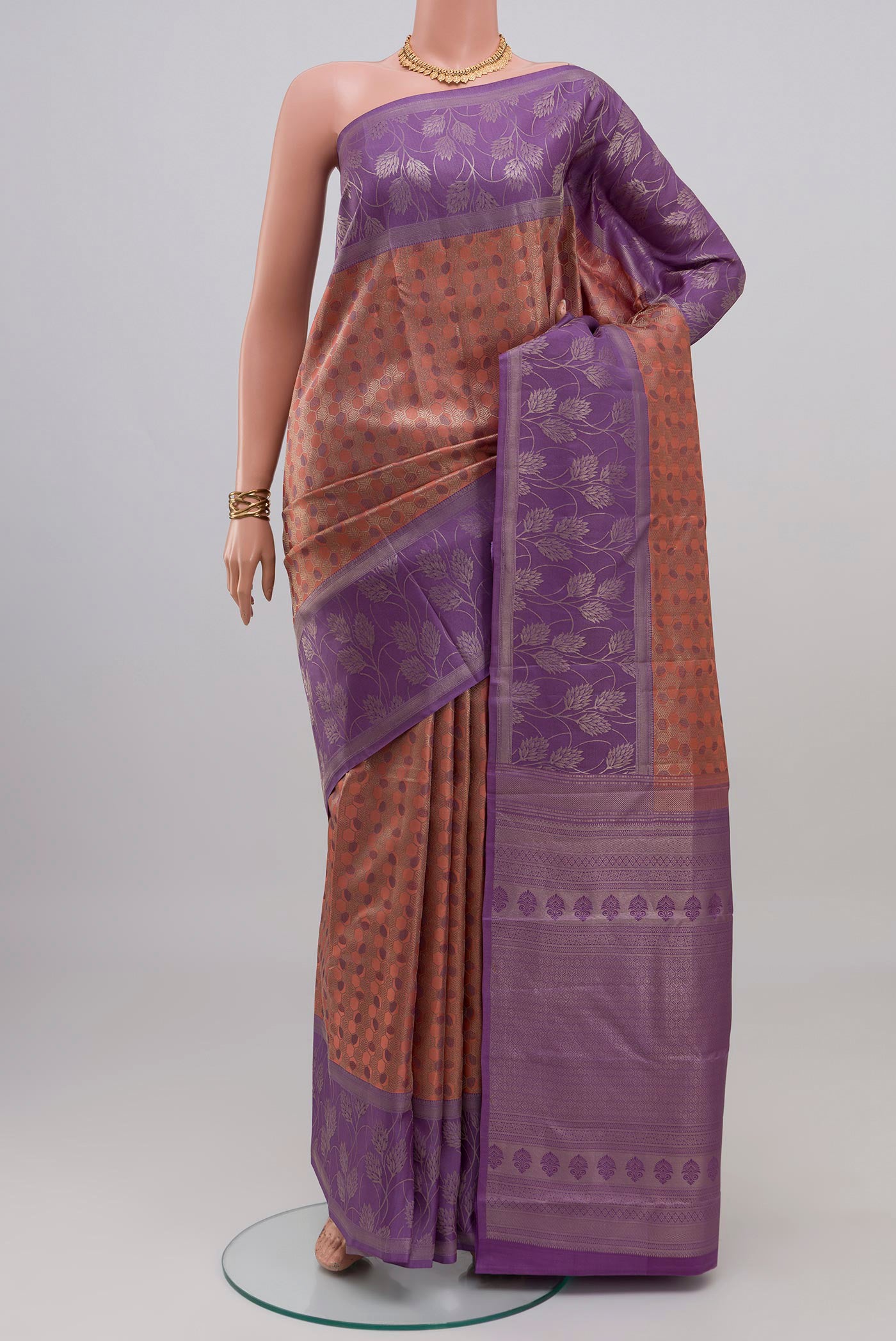 Mauve Kanchipuram Silk Saree with Zari Brocade on the body and Fancy Border.  displayed on a mannequin