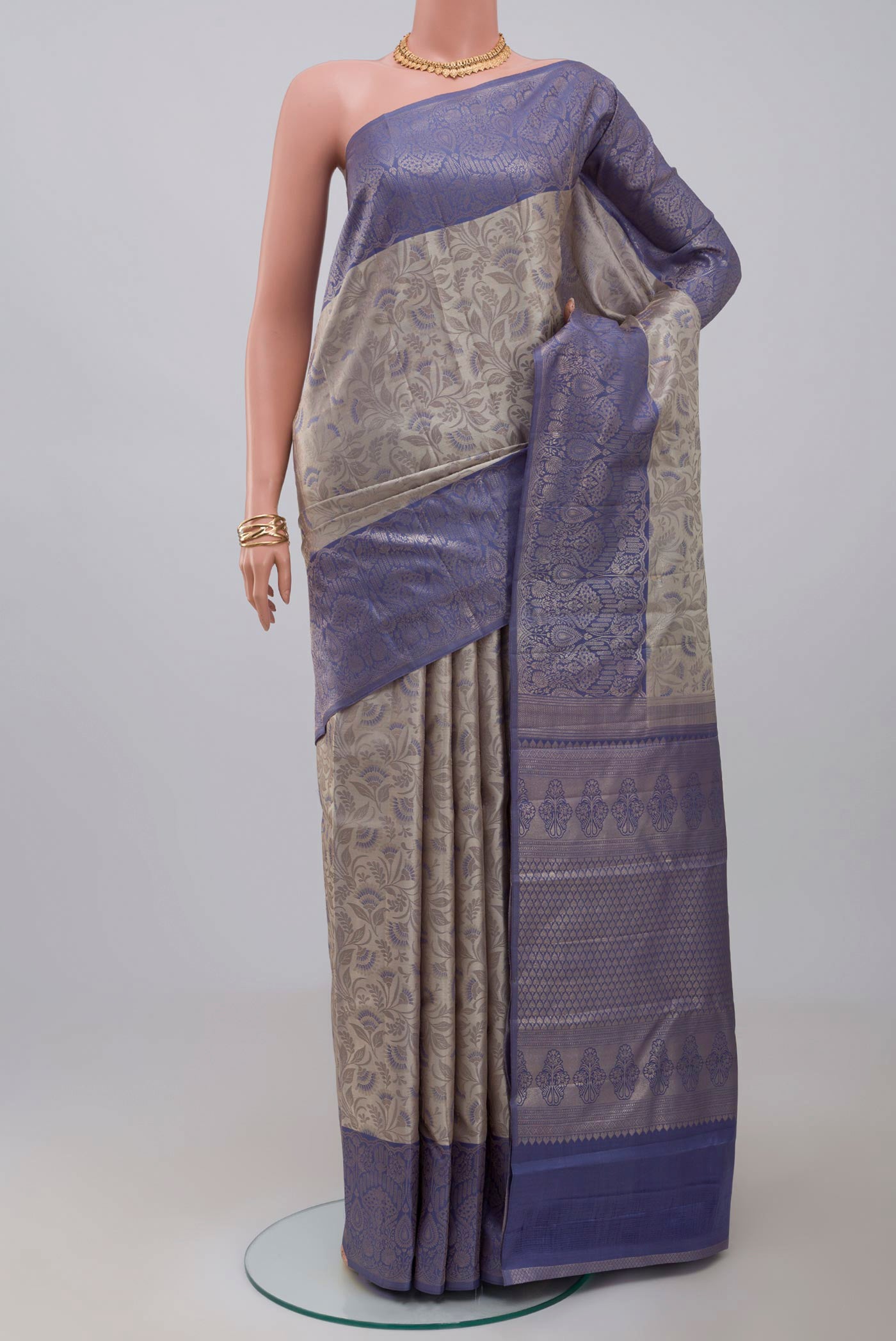 Grey Kanchipuram Saree with Zari Brocade on the body and Fancy Border.  displayed on a mannequin