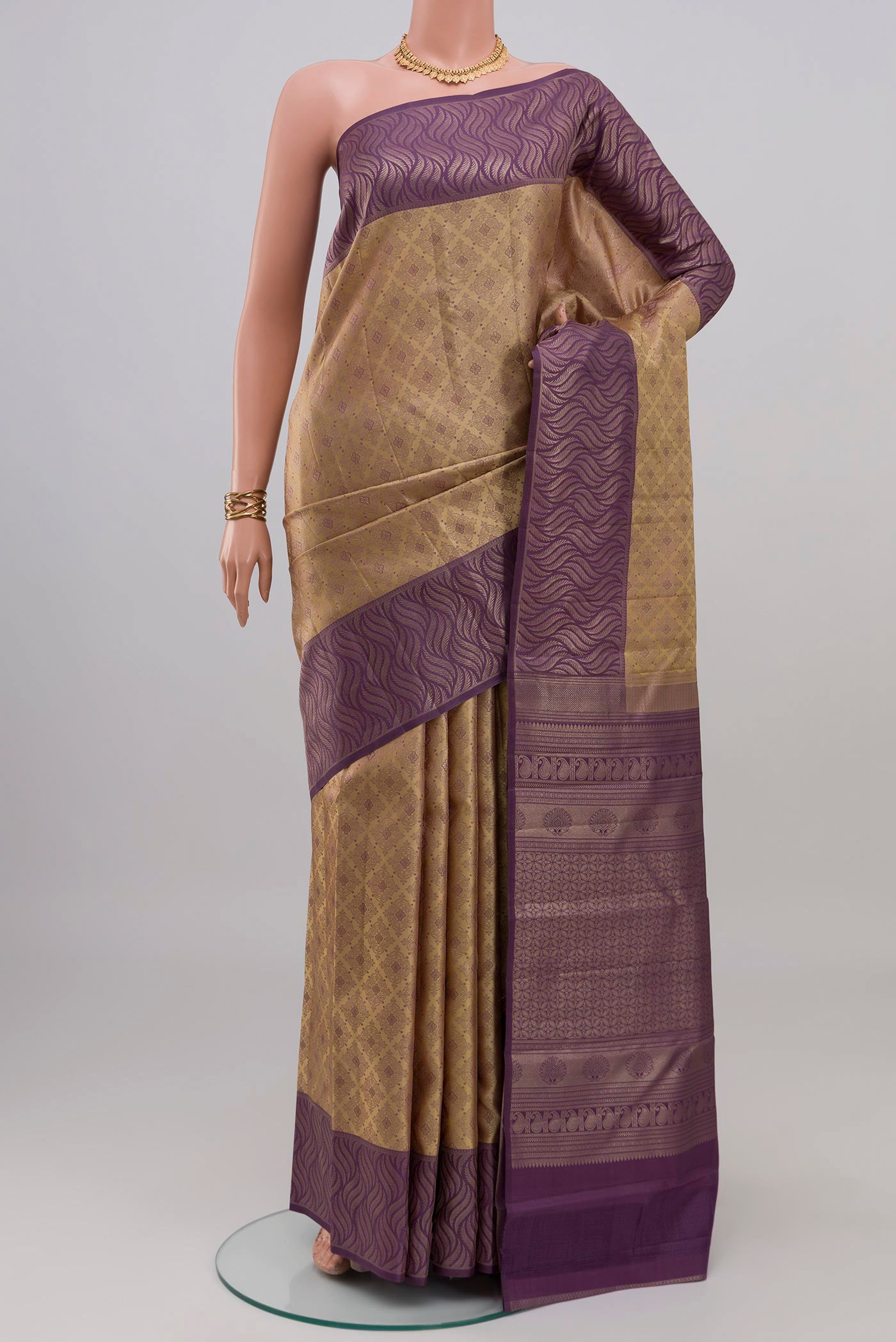Beige Kanchipuram Silk Saree with Zari Brocade on the body and Fancy Border.  displayed on a mannequin