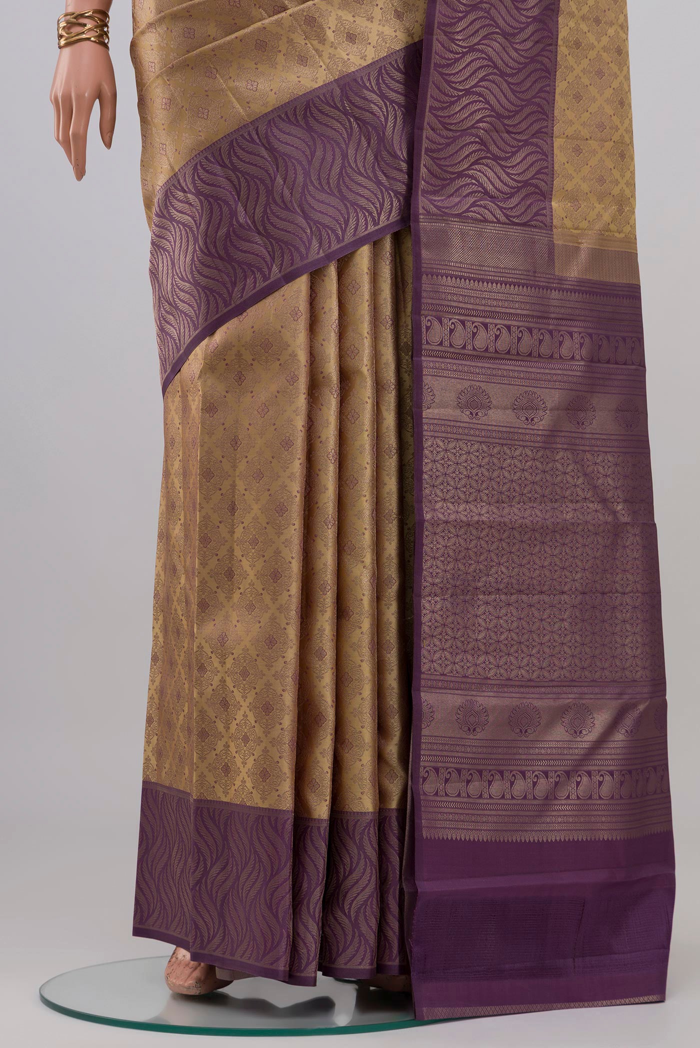 Pleats and pallu of Beige Kanchipuram Silk Saree with Zari Brocade on the body and Fancy Border. 