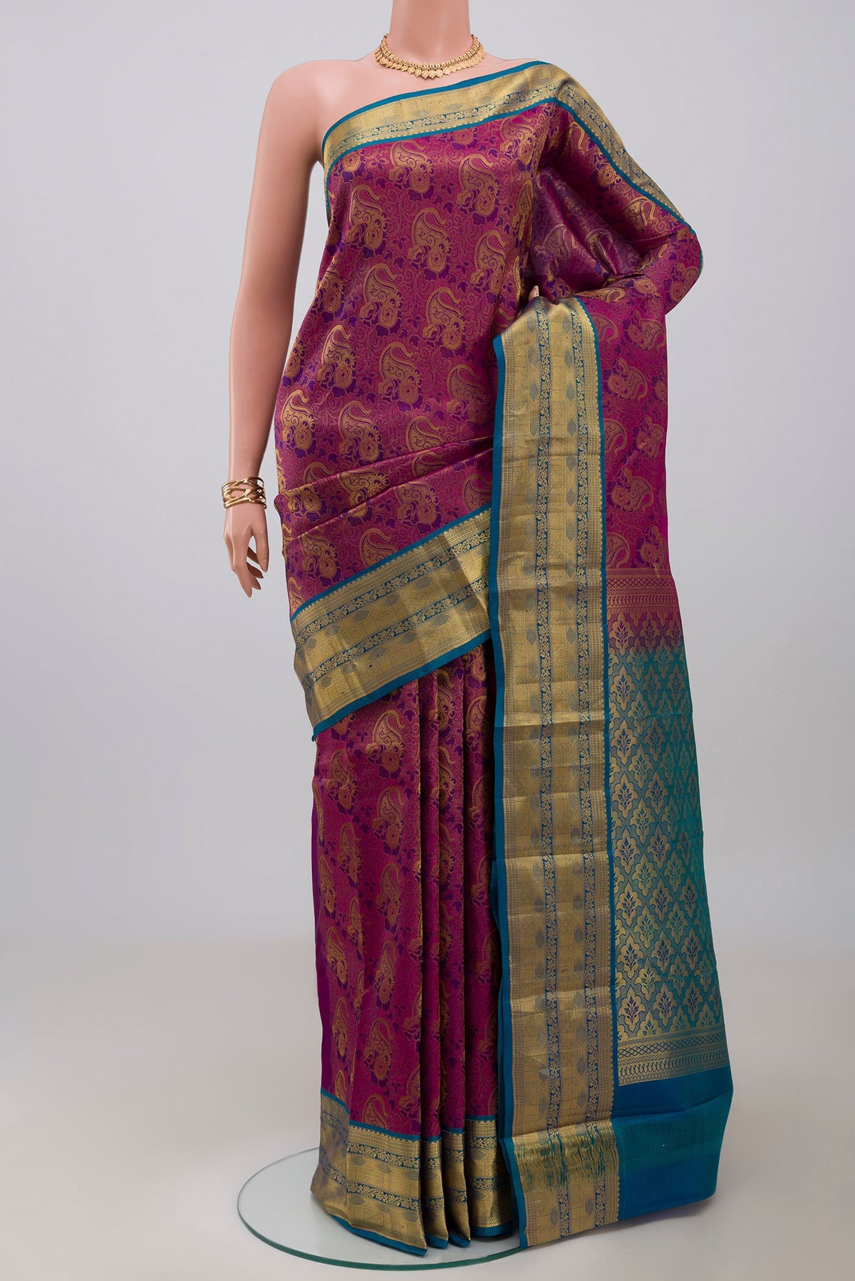 Purple Kanchipuram Saree with Zari Brocade on the body and Zari Border.  displayed on a mannequin