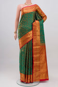 Green Kanchipuram Silk Saree with Jacquard design on the body and Zari Border.  displayed on a mannequin