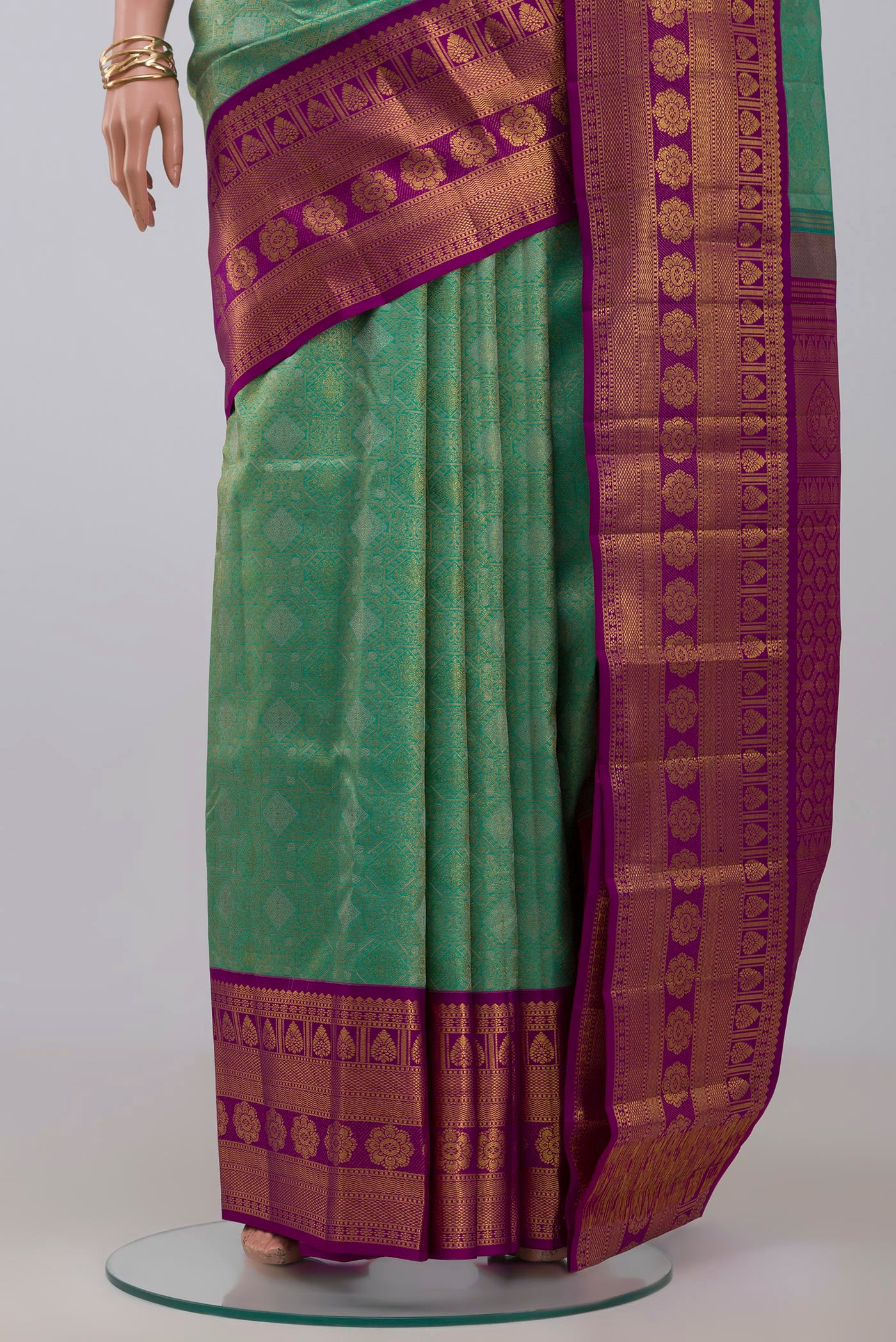 Pleats and pallu of Green Kanchipuram Silk Saree with Zari Brocade on the body and Zari Border. 