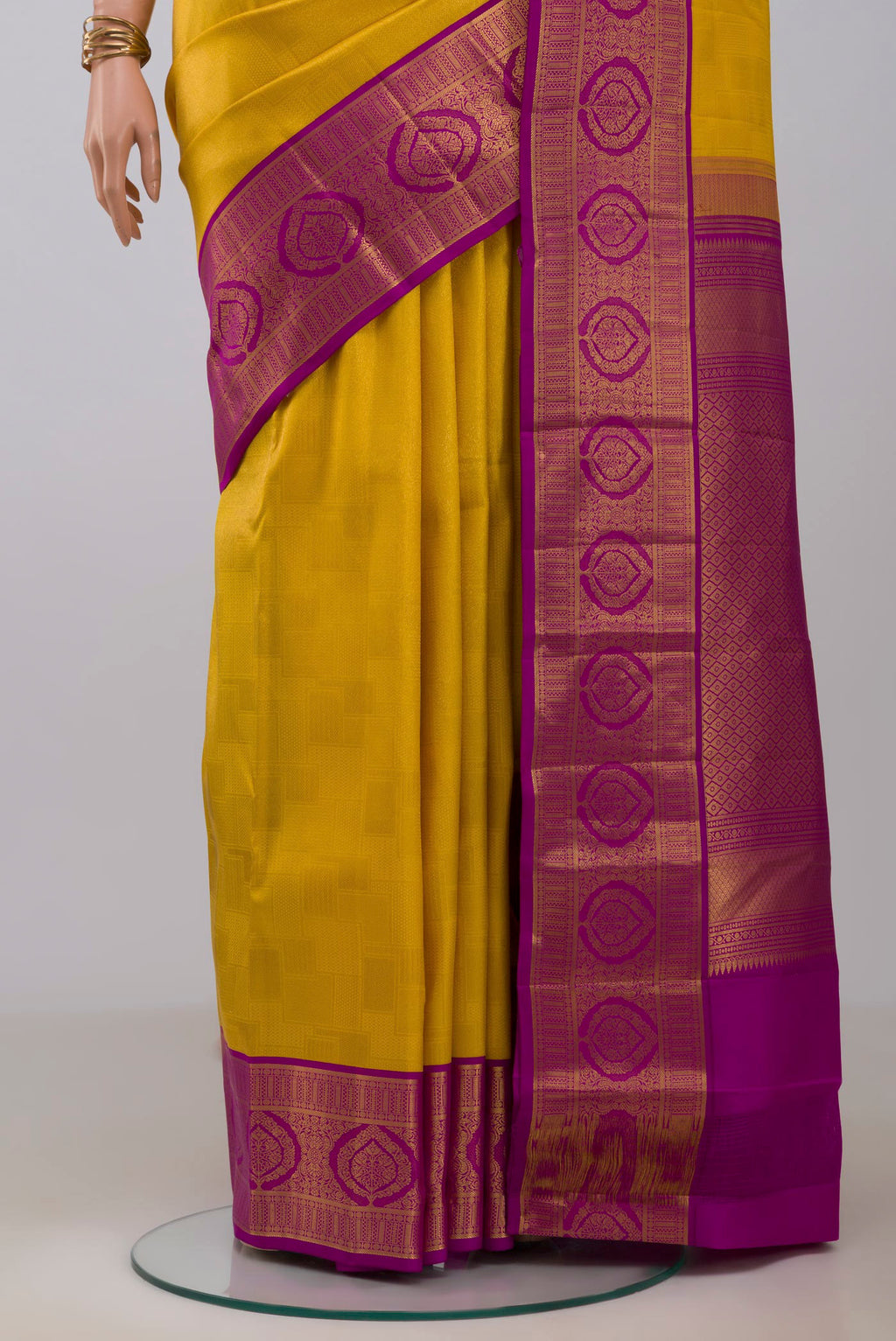 Pleats and pallu of Yellow Kanchipuram Silk Saree with Zari Brocade on the body and Zari Border. 