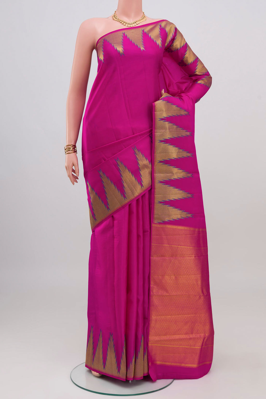 Rani Pink Kanchipuram Silk Saree with Plain Body and Temple Border.  displayed on a mannequin