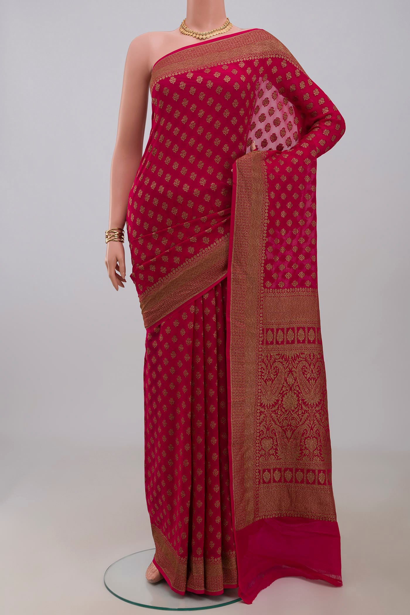 Pink Georgette Saree with Fancy on the body and Fancy Border.  displayed on a mannequin
