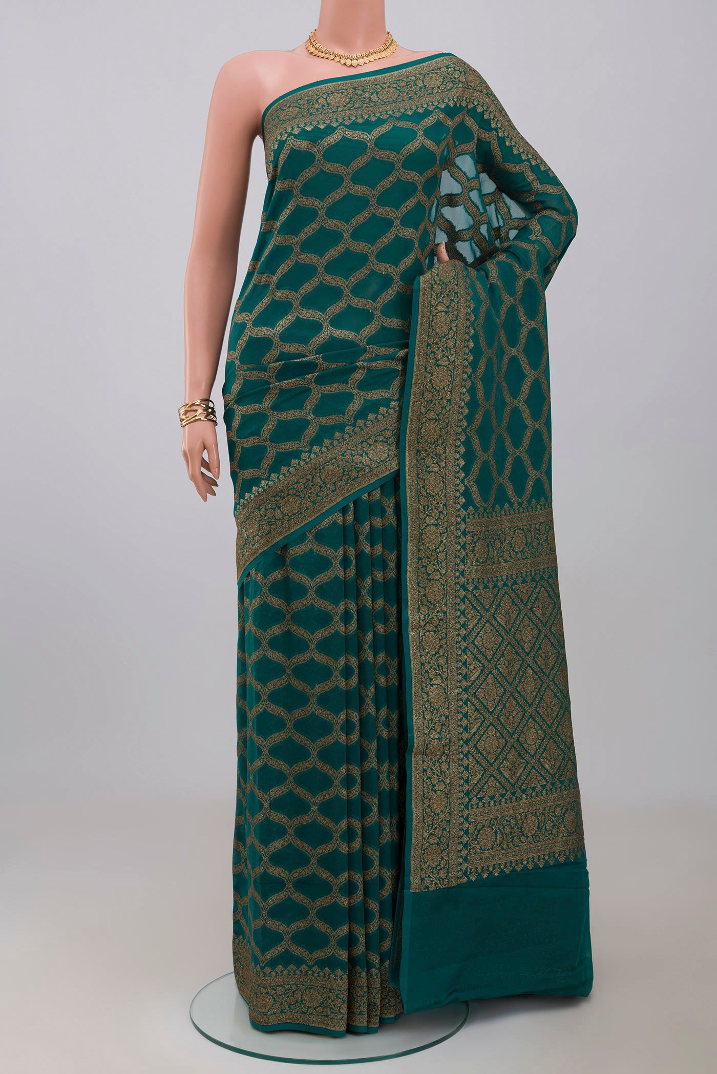 Green Georgette Saree with Fancy on the body and Zari Border.  displayed on a mannequin
