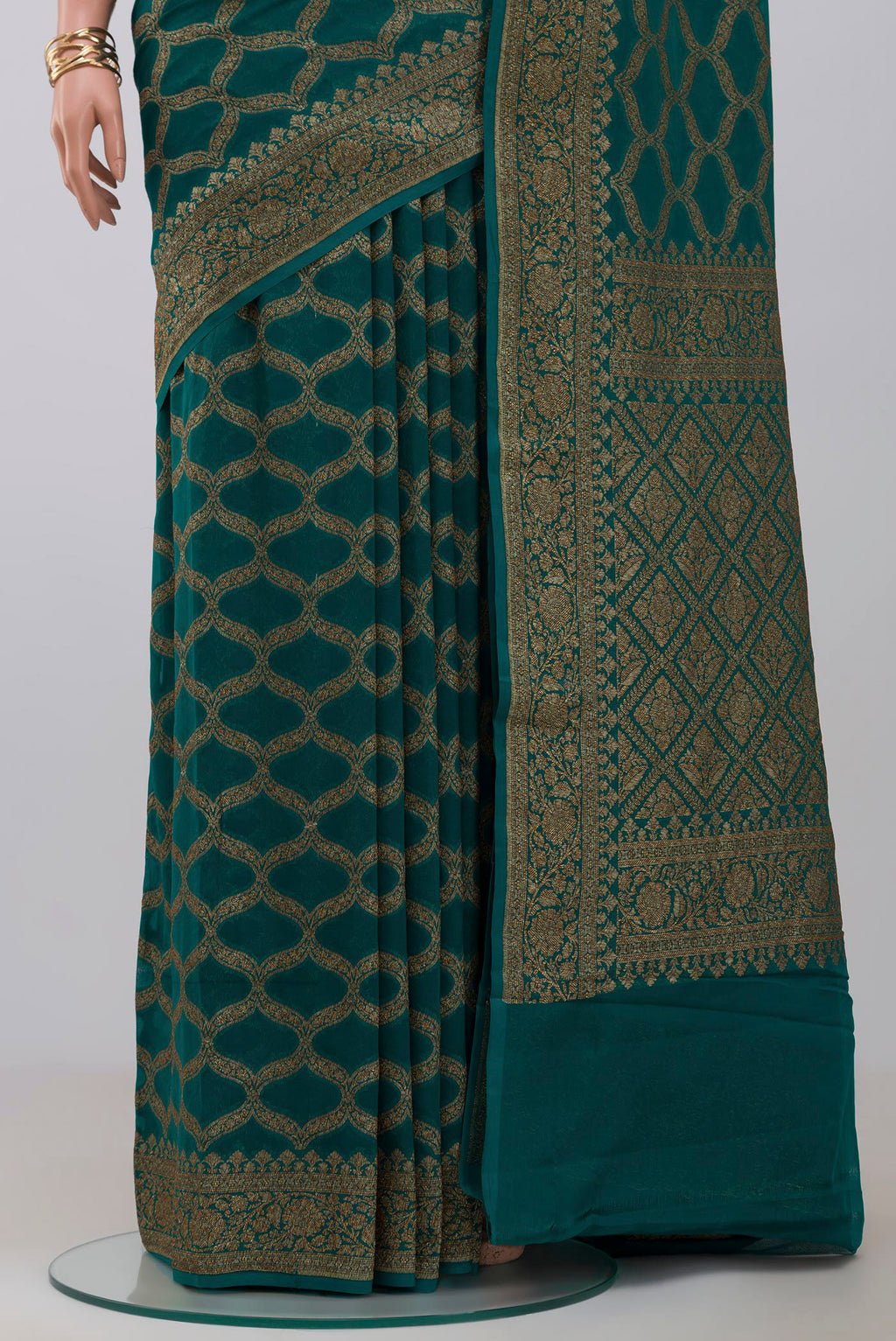 Pleats and pallu of Green Georgette Saree with Fancy on the body and Zari Border. 
