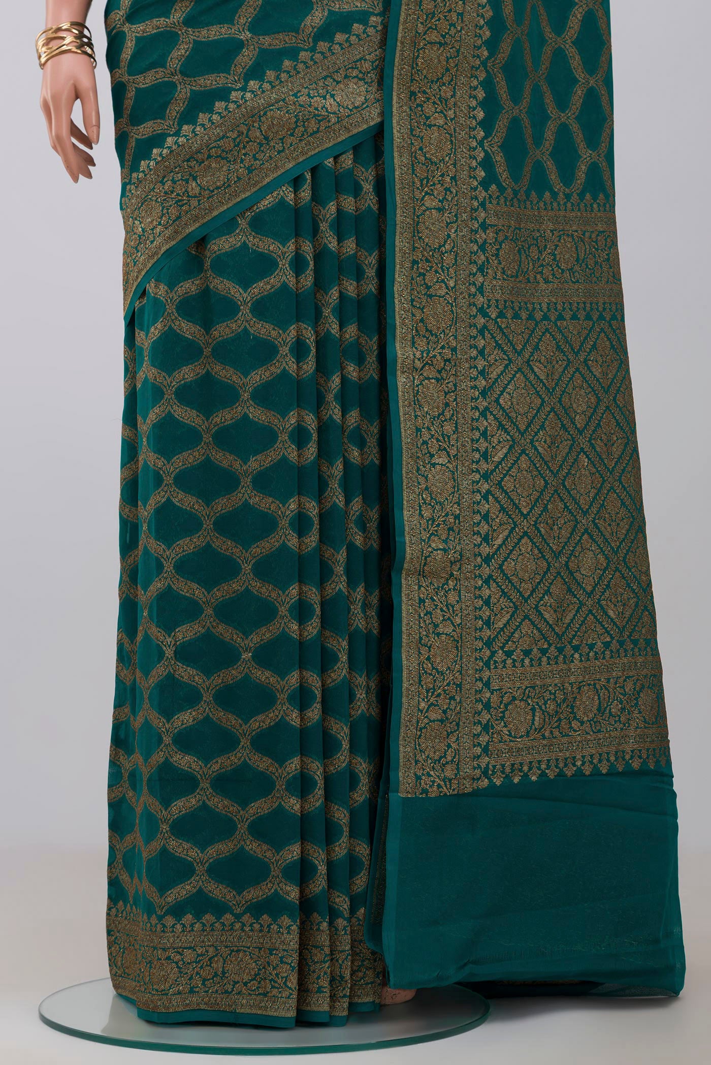 Pleats and pallu of Green Georgette Saree with Fancy on the body and Zari Border. 