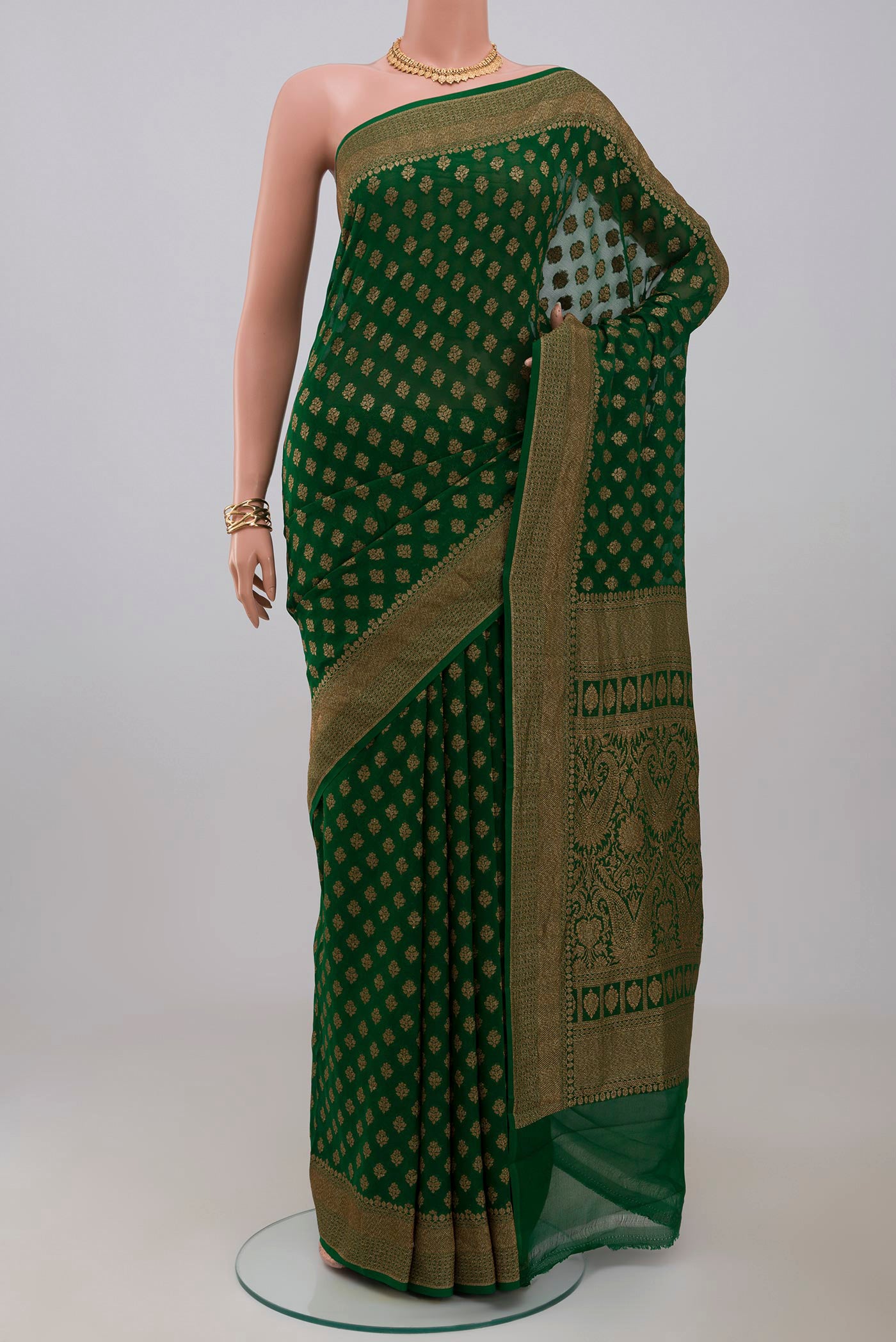 Green Georgette Saree with Fancy on the body and Fancy Border.  displayed on a mannequin