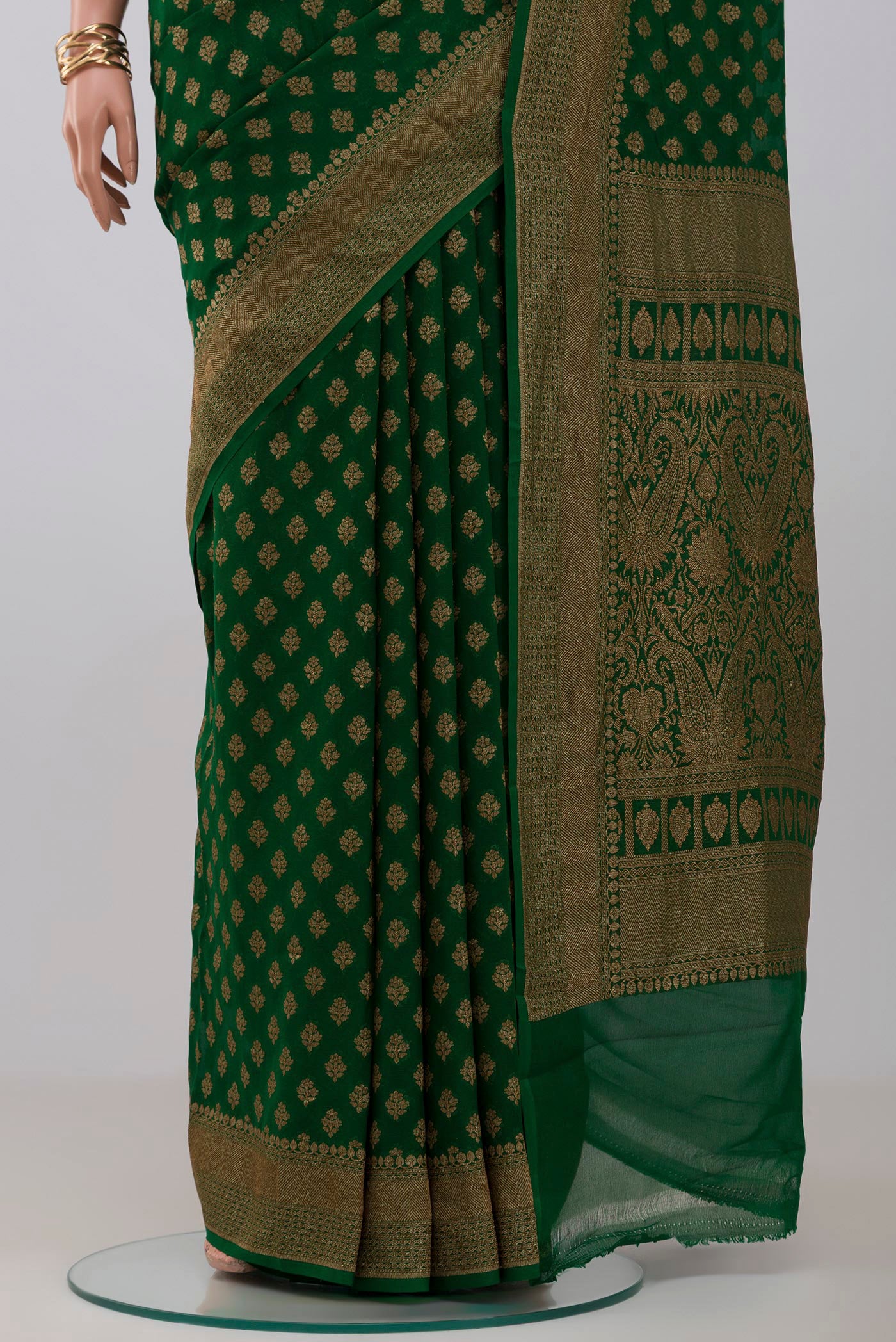 Pleats and pallu of Green Georgette Saree with Fancy on the body and Fancy Border. 