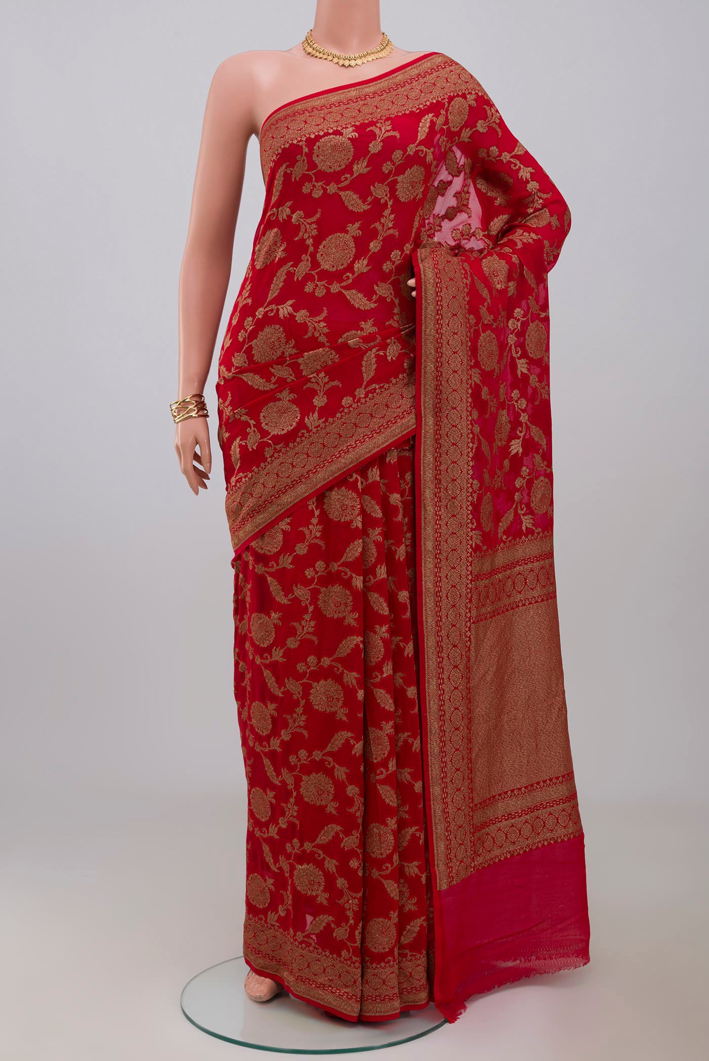 Red Georgette Saree with Fancy on the body and Fancy Border.  displayed on a mannequin