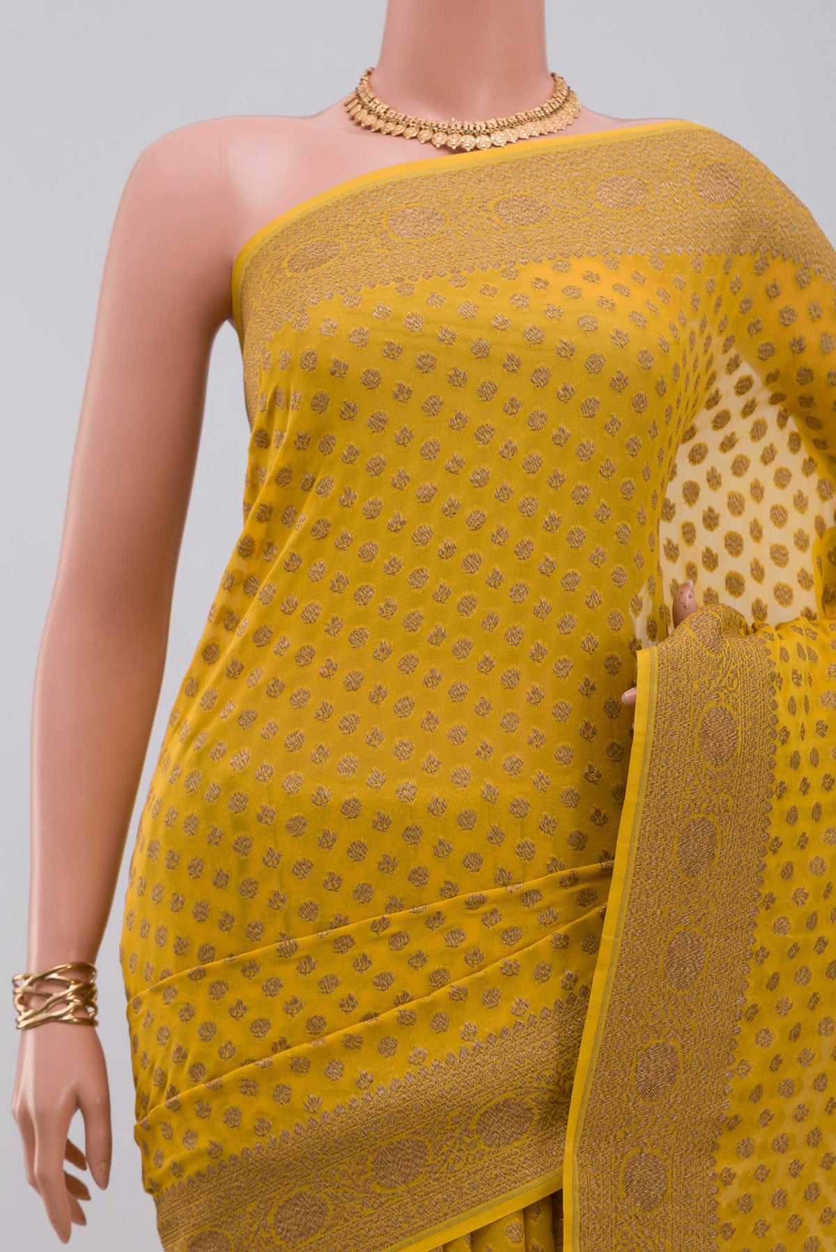 Border image of Yellow Georgette Saree with Fancy on the body and Fancy Border. 