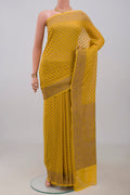 Yellow Georgette Saree with Fancy on the body and Fancy Border.  displayed on a mannequin